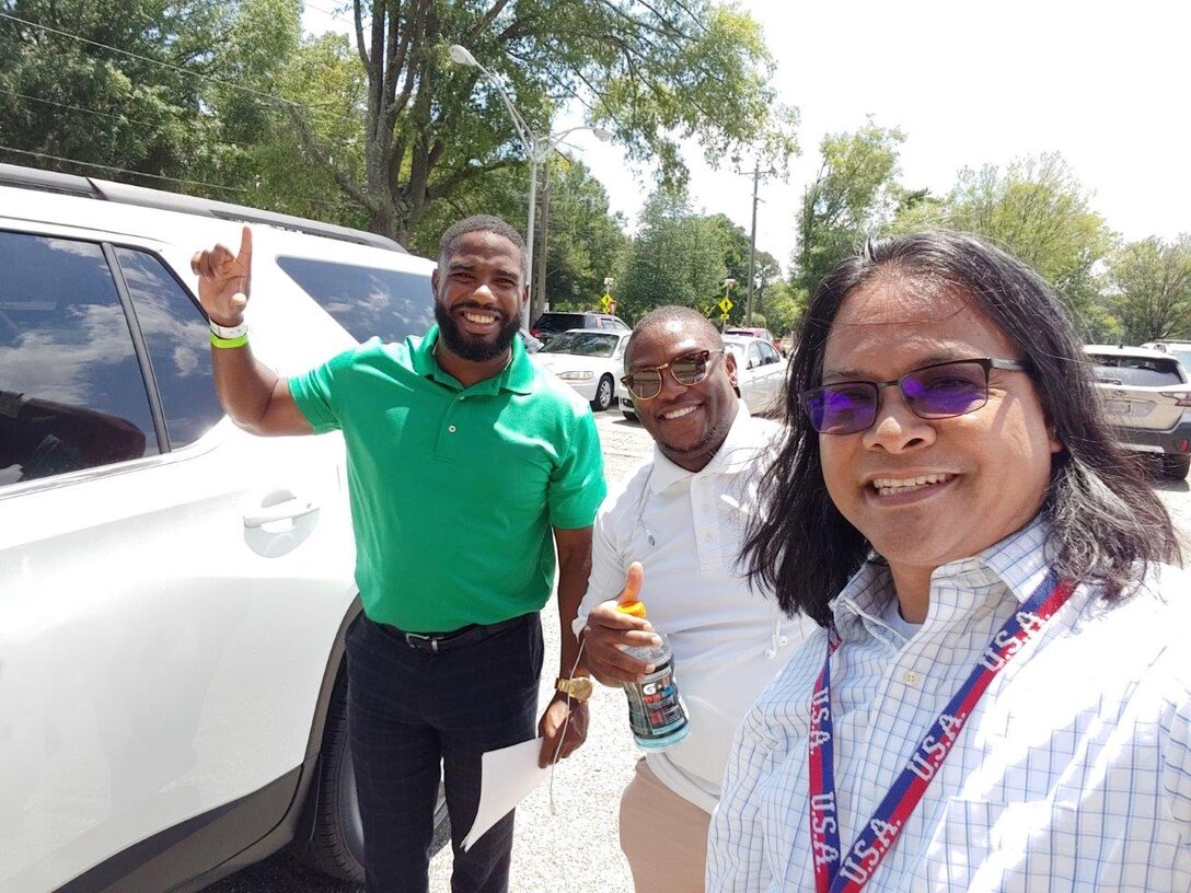 Members of a van pool pose for a picture.