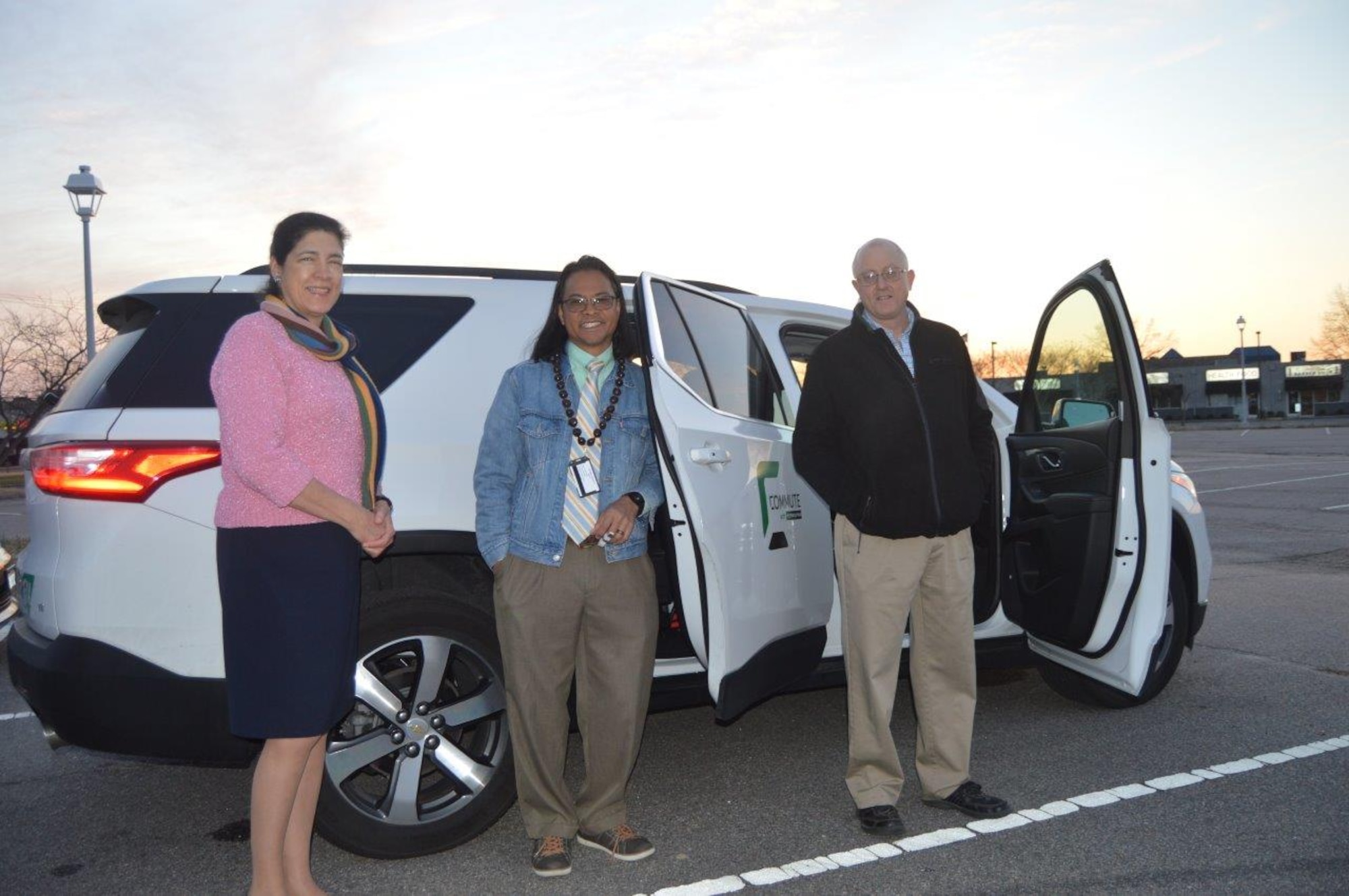 Members of a van pool pose for a picture.