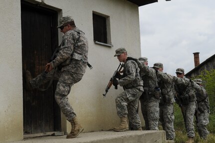 Soldiers from the Vermont Army National Guard prepare to clear a target house at the Krivolak Training Area, North Macedonia, May 25, 2012. Soldiers participating in Exercise Cooperative Lancer had the opportunity to train from the classroom, to the sand tables and then incorporate that training out into the field. (U.S. Air National Guard photo by Staff Sgt. Sarah Mattison)