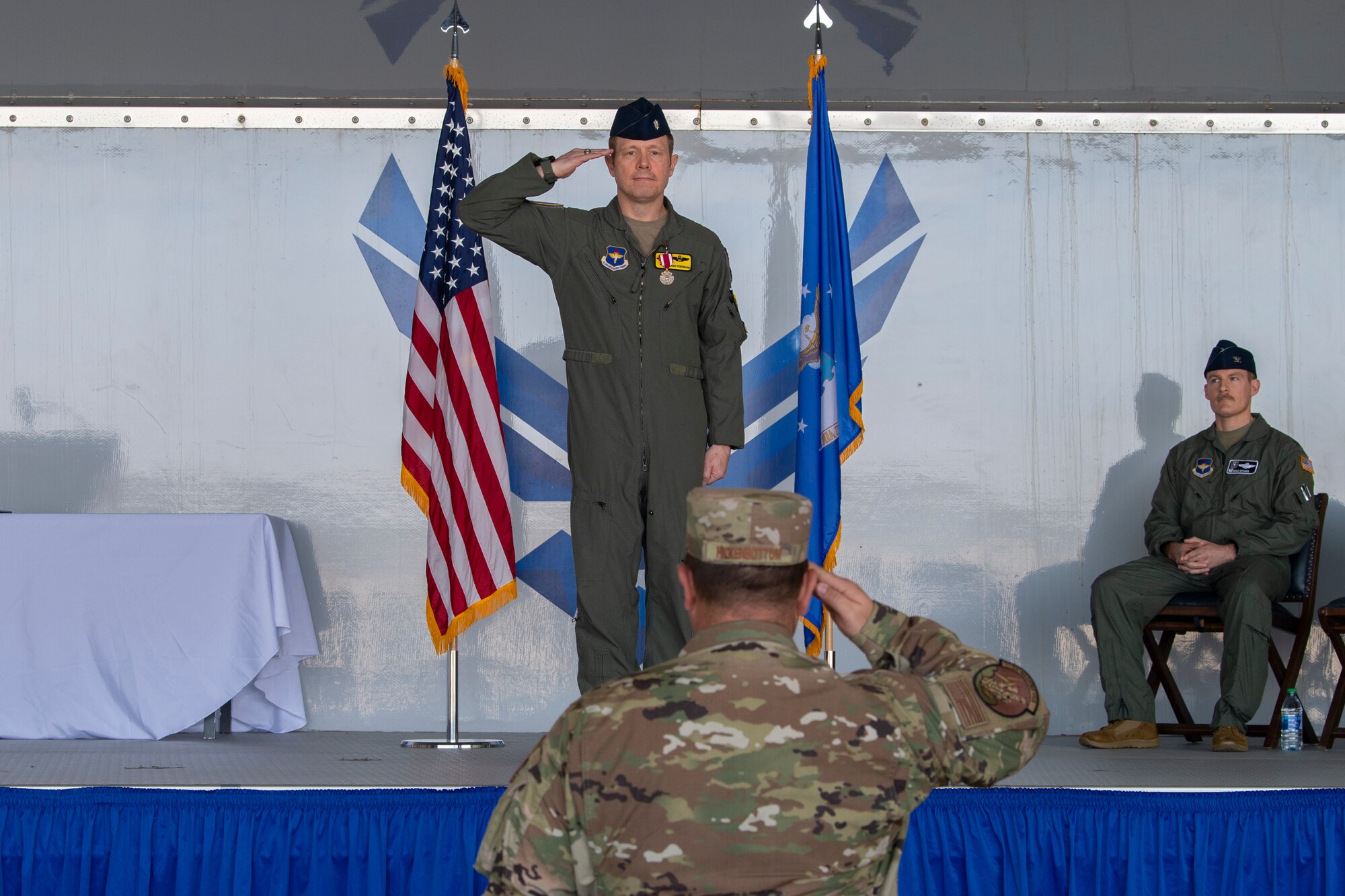 A photo of two service members saluting each other.
