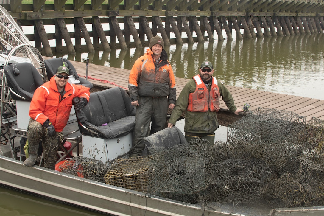 WALLISVILLE, Texas -- USACE Galveston Natural Resource Specialists (from left to right) Eric Angle, Mark Tyson, and Brandon Moerhle spent all day Thursday, February 24, touring the Wallisville Lake Project on an airboat and picking up discarded and abandoned traps along the way.

The park rangers collected more than a dozen traps, which entrap and kill aquatic and terrestrial wildlife and damage recreational boats on the lake.