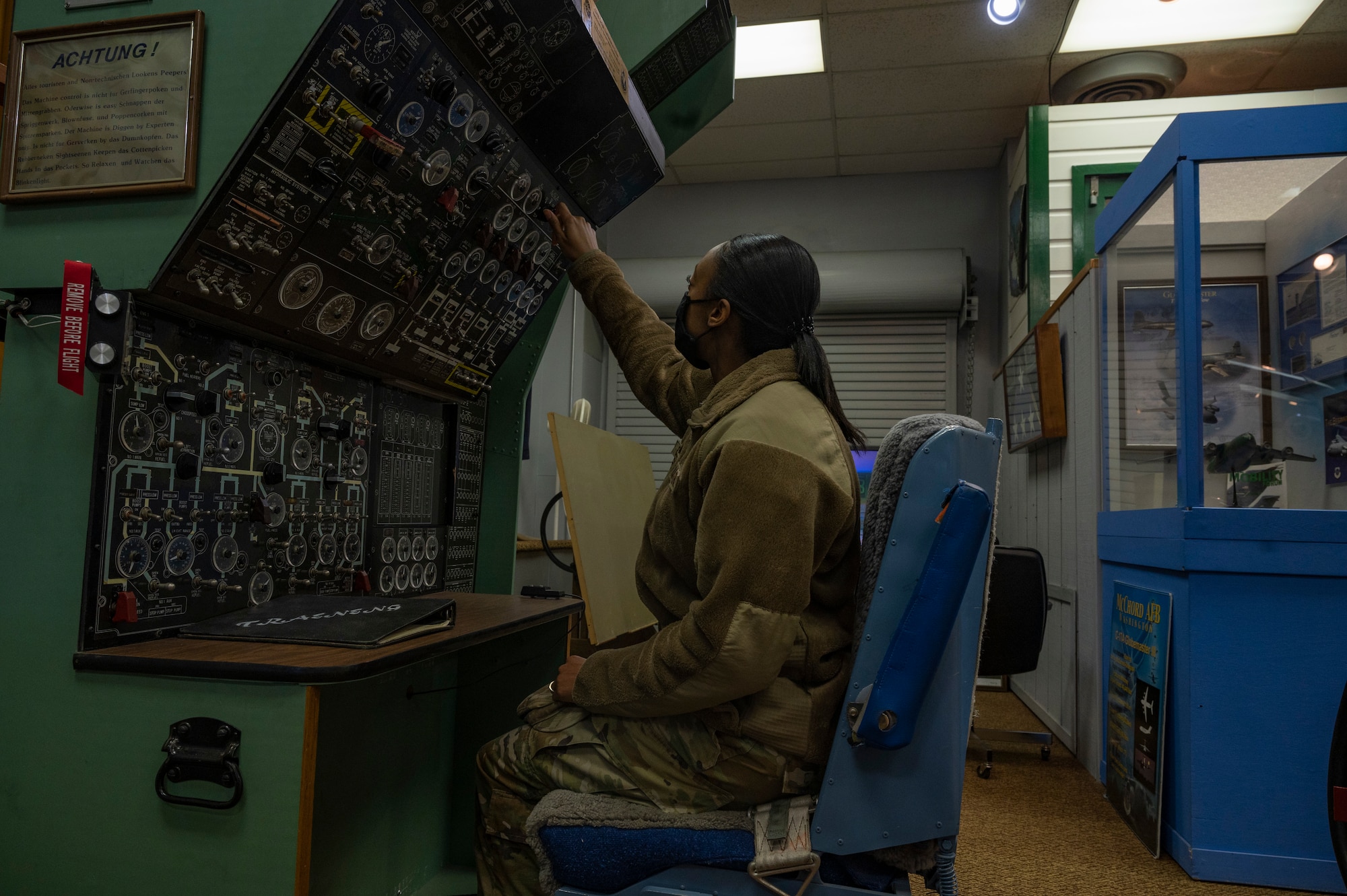 An Airman assigned to the 62nd Airlift Wing sits in an old aircraft simulator in the McChord Air Museum at Joint Base Lewis-McChord, Washington, Feb. 22, 2022. After being closed for almost two years due to the COVID-19 pandemic, the Air Museum reopened its doors to the public. (U.S. Air Force photo by Airman 1st Class Charles Casner)