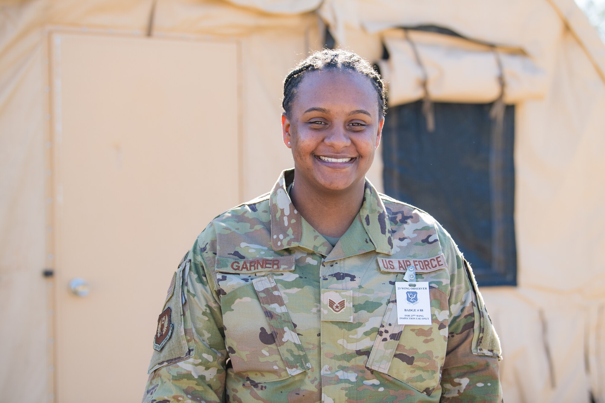 A service member poses for a photograph