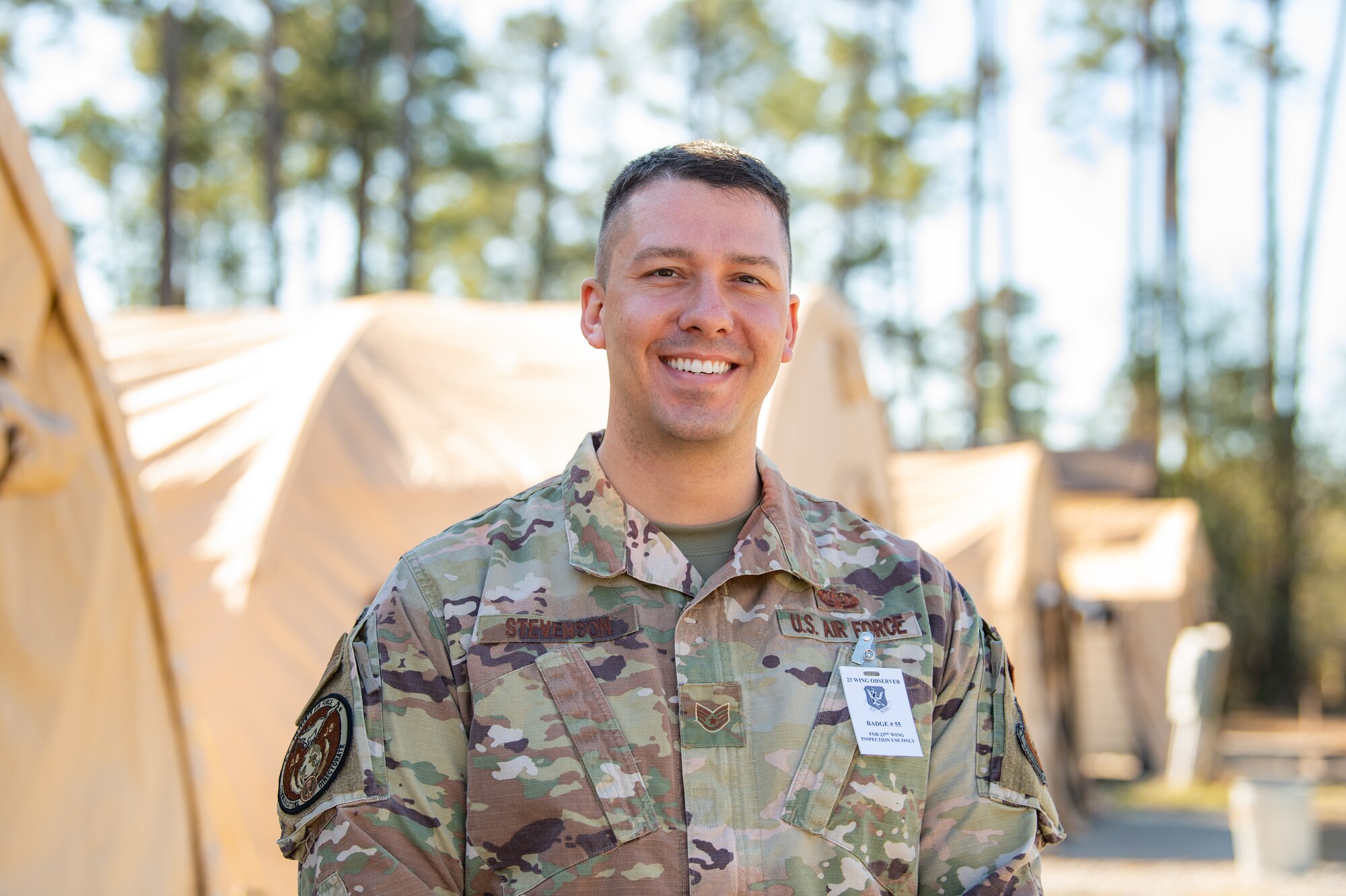 A service member poses for a photograph