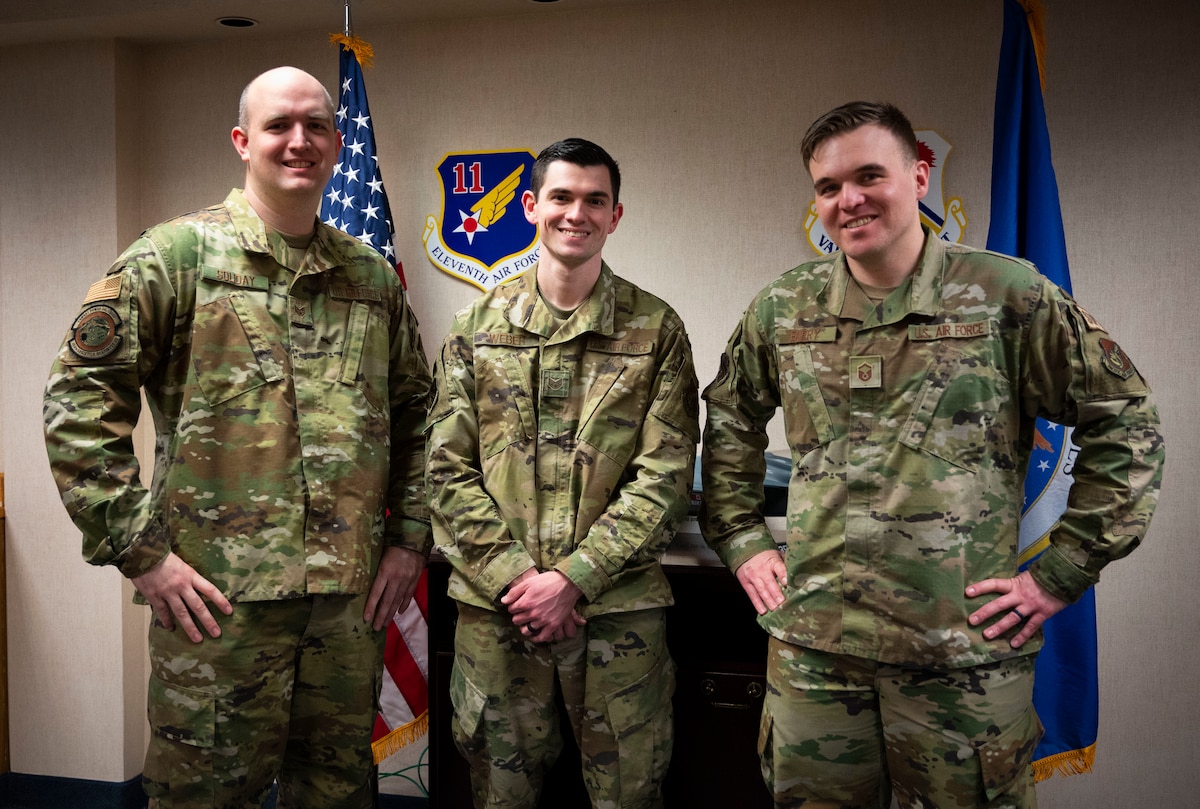 U.S. Air Force Staff Sgt. Kyle Soliday, 354th Logistics Readiness Squadron materiel management user and developer (left); Staff Sgt. Shane Weber, 354th Fighter Wing protocol specialist (center); and Master Sgt. Philip Barry, 354th Fighter Wing director of innovation (right), pose for a group photo representing the Iceman Spark team at Eielson Air Force Base, Alaska, March 4, 2022.