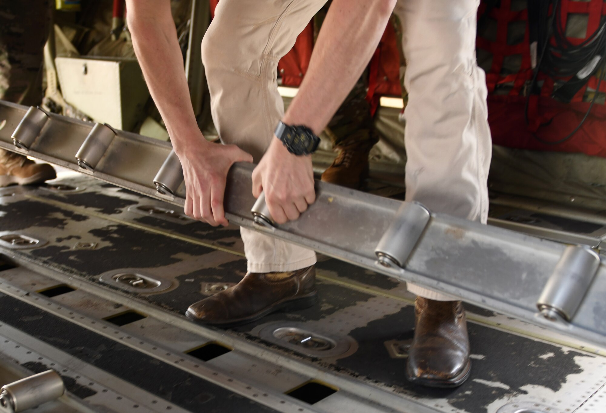 An Auburn University engineering student studies aircraft parts for research Feb 16, 2022 at Maxwell Air Force Base, Al. Air University’s Innovation Center and MGMWERX partnered with the 187th Fighter Wing and the 908th airlift wing to provide Auburn University students with a C-130 loading demo and C-17 static. (U.S. Air Force photo by Senior Airman Rhonda Smith)