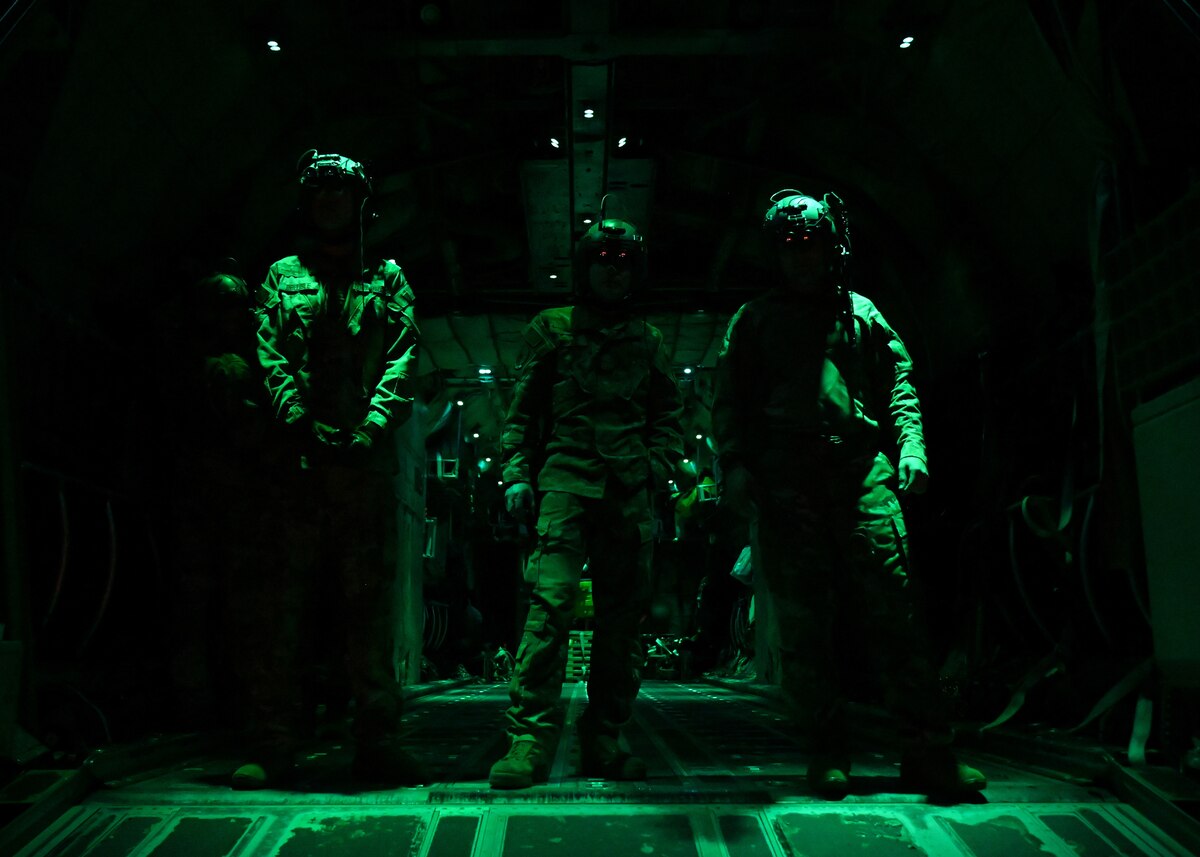 A pilot from the 41st Airlift Squadron installs a chair support beam in a C-130J Super Hercules