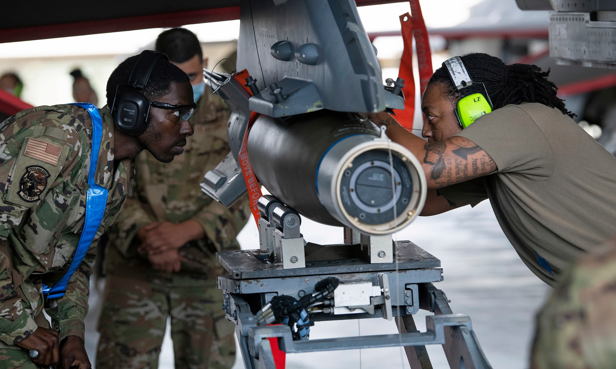 A 96th Aircraft Maintenance Squadron team secures a GBU-12 on to an F-16 Fighting Falcon