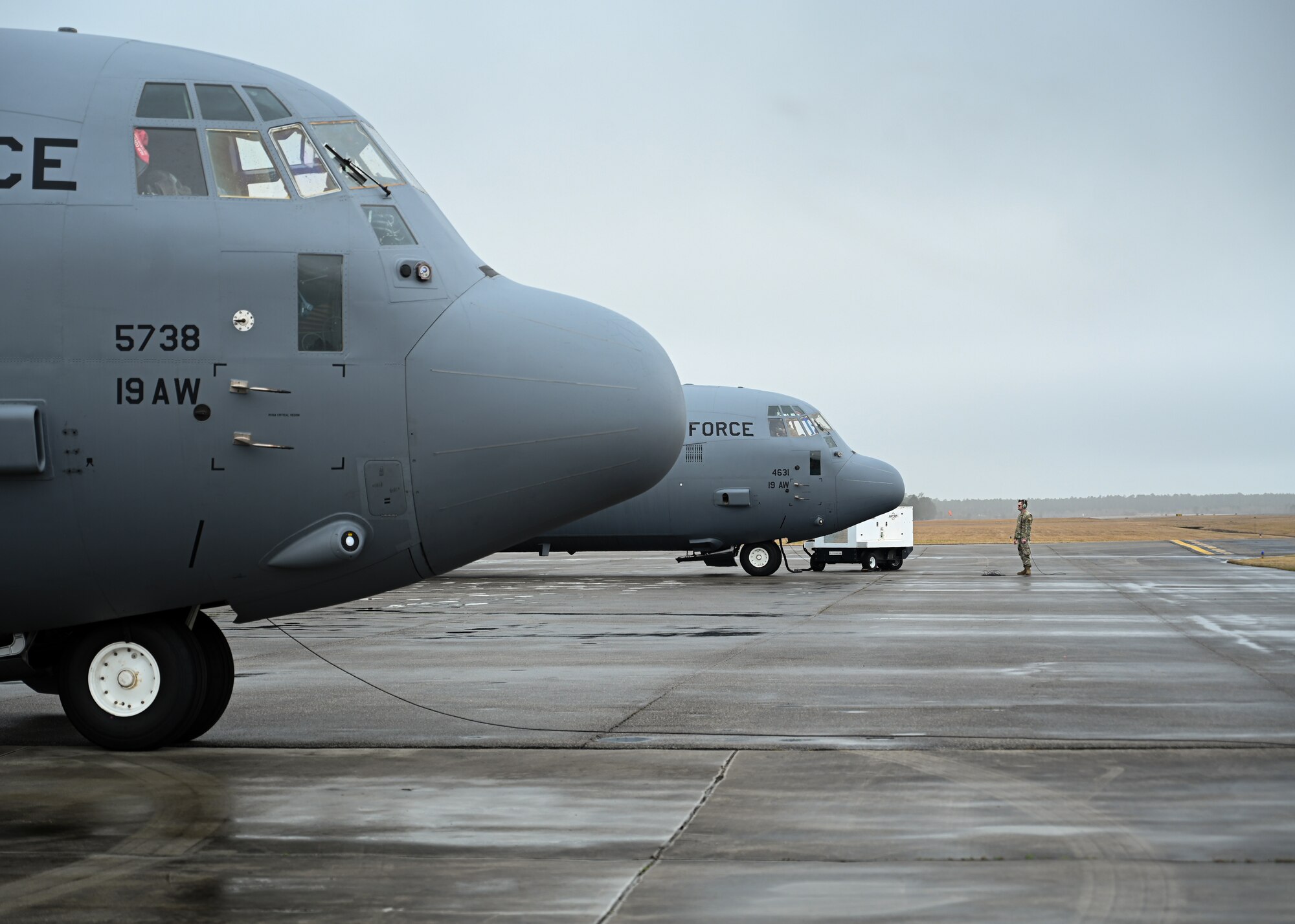 An Airman assigned to the19th Aircraft Maintenance Squadron watches as a C-130J Super Hercules prepares to taxi