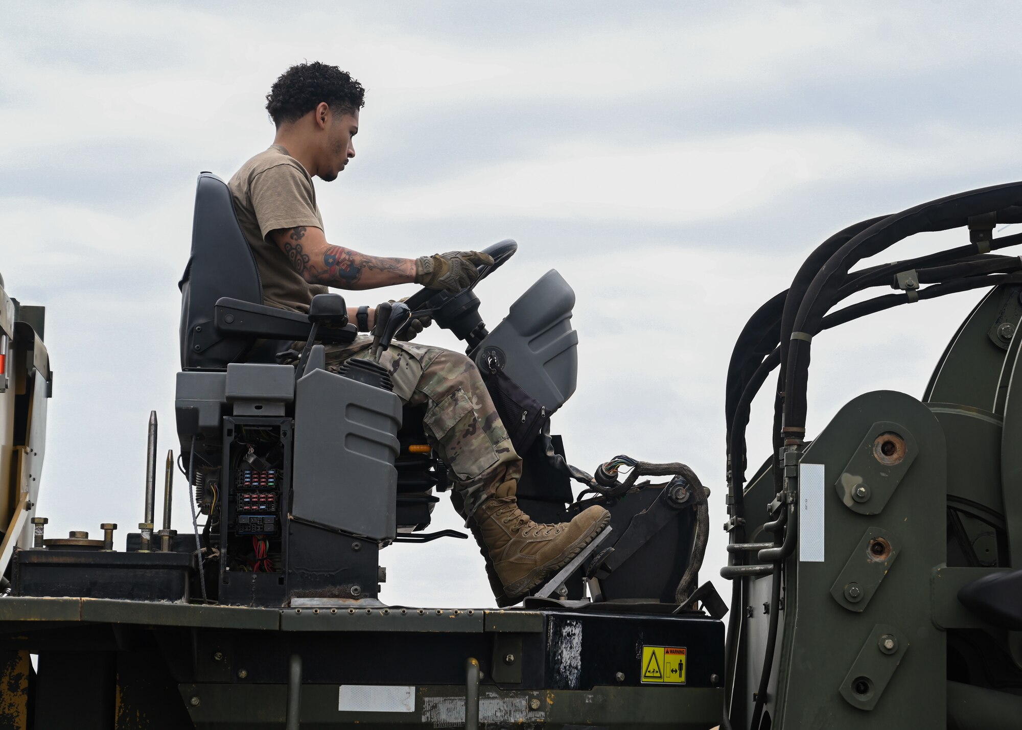 An Airman from the 621st Contingency Response Wing loads cargo into a C-130J Super Hercules