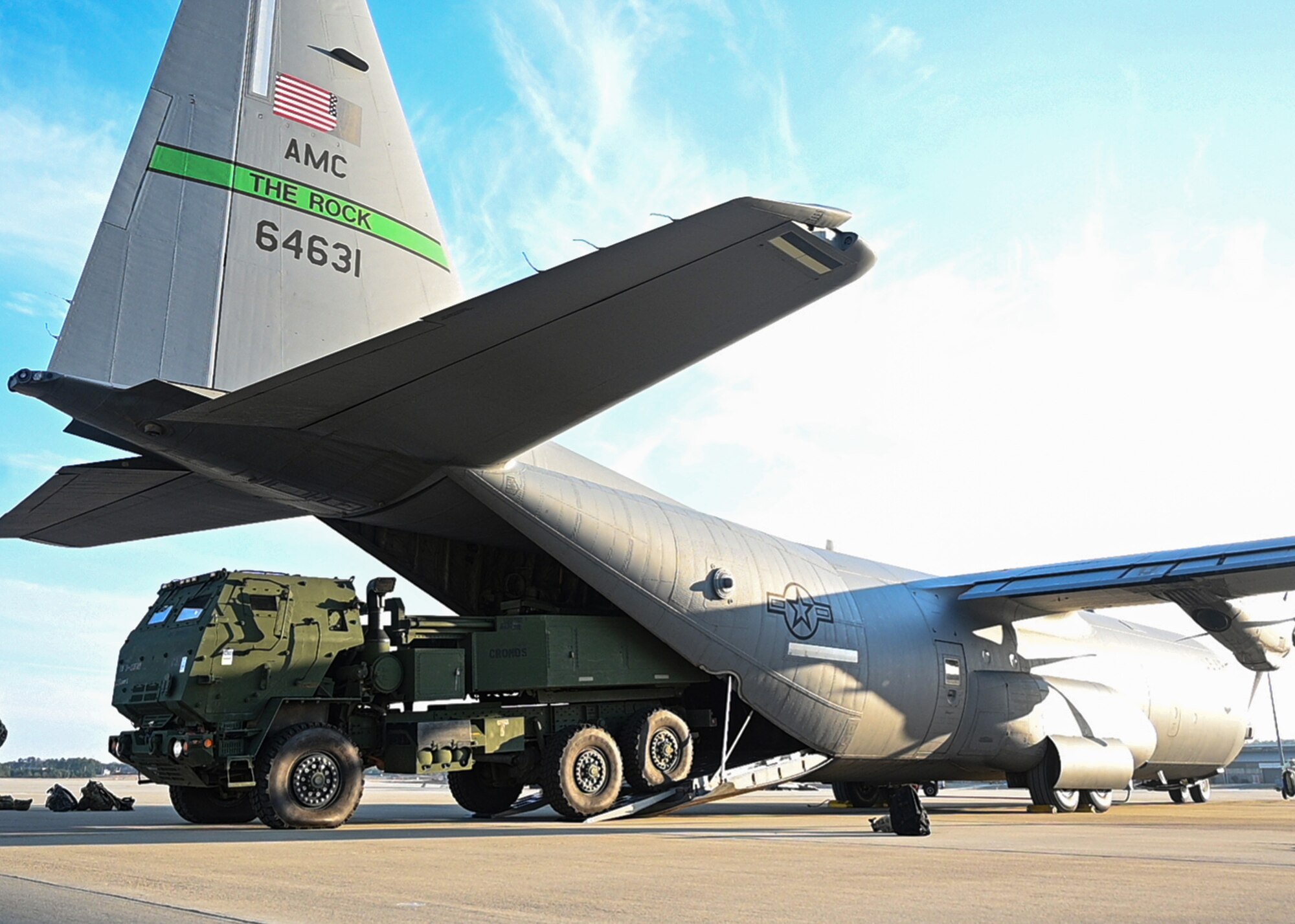 A High Mobility Artillery Rocket System is loaded onto a C-130J Super Hercules