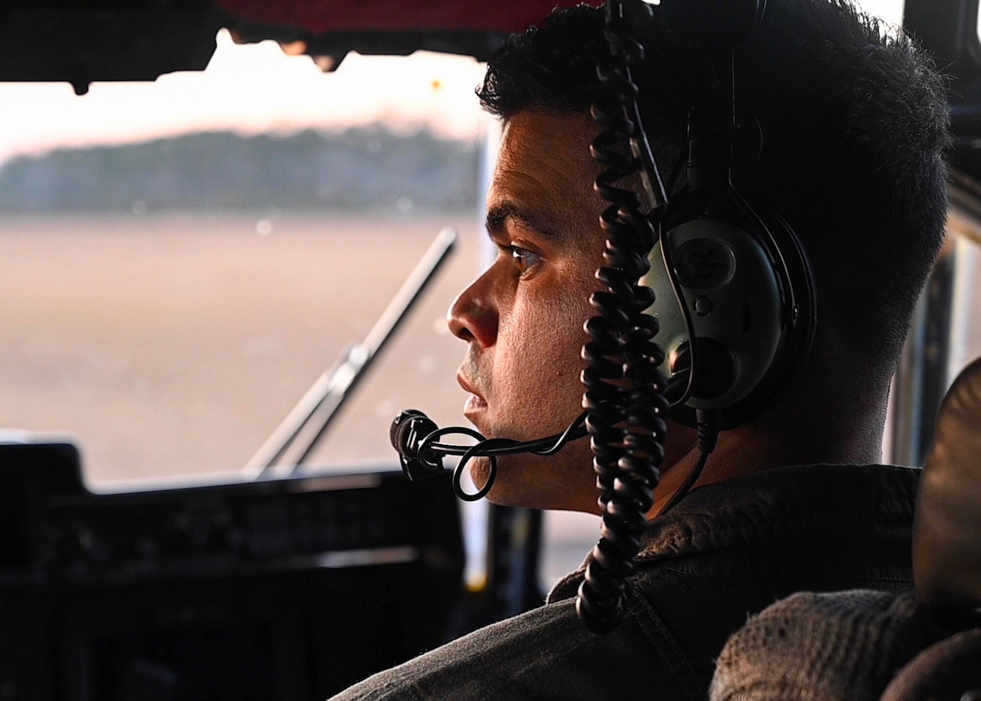 A loadmaster from the 327th Airlift Squadron performs pre-flight checks on a C-130J Super Hercules