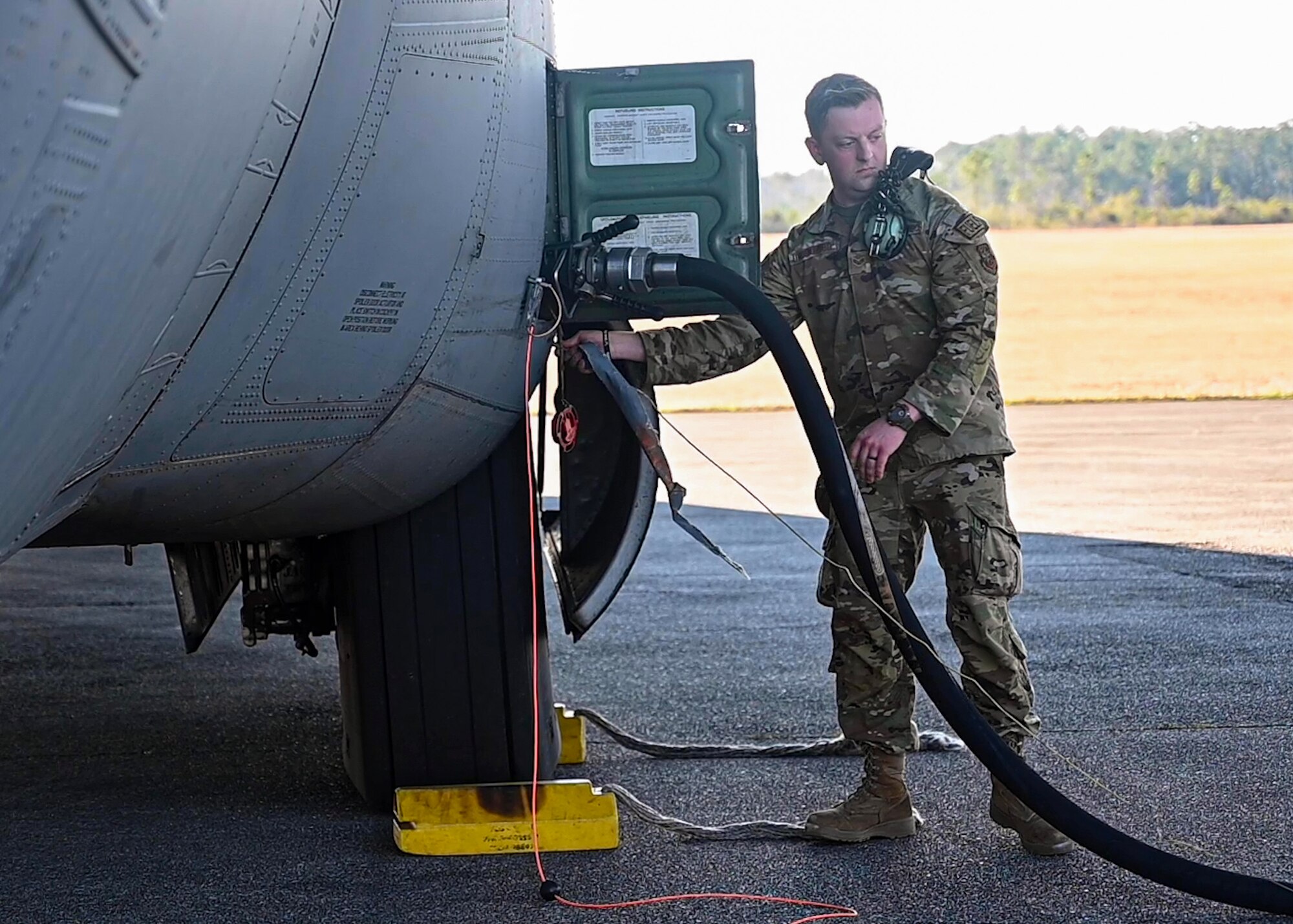 An Airman from the 19th Aircraft Maintenance Squadron refuels a C-130J Super Hercules