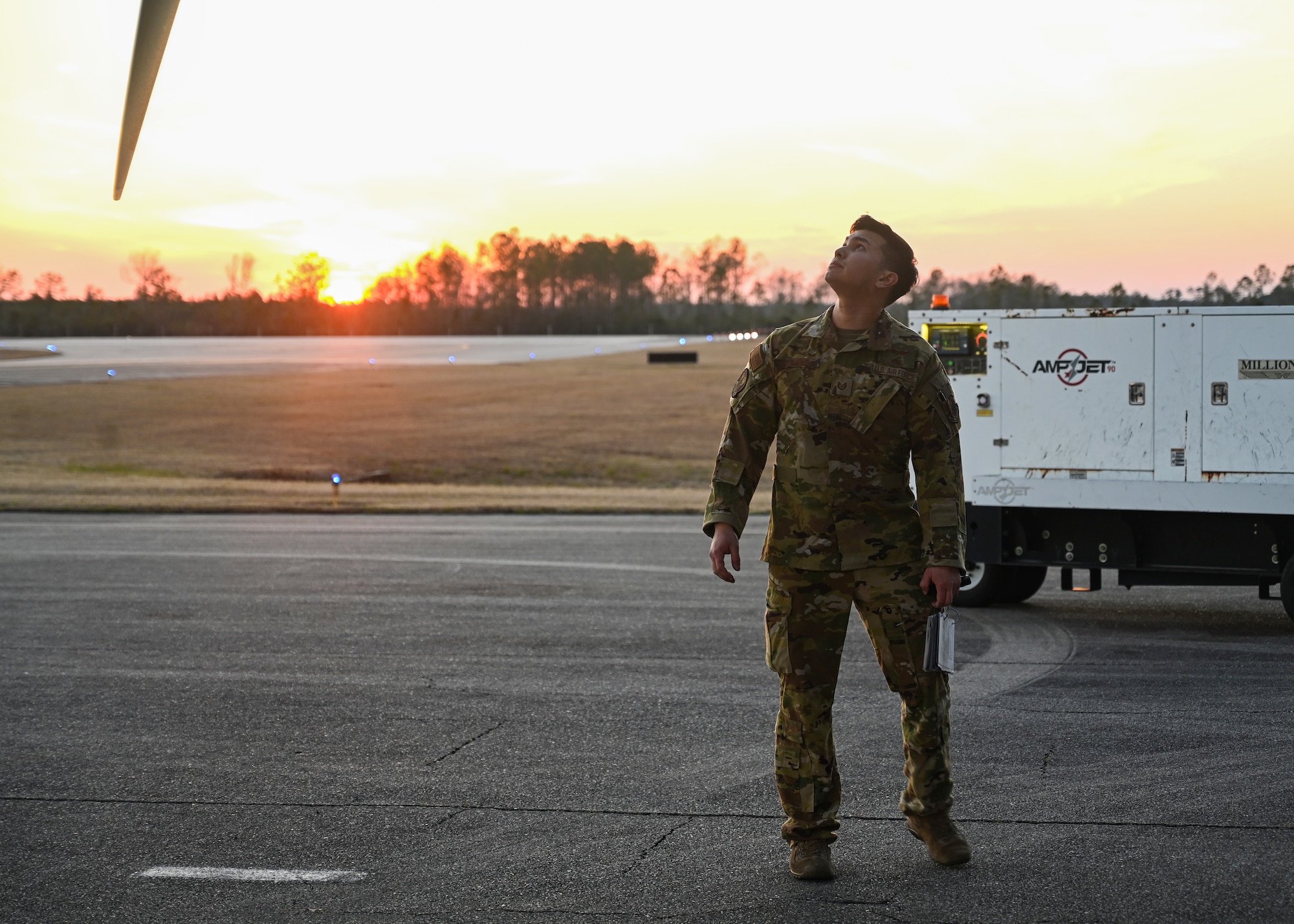 A loadmaster from the 327th Airlift Squadron performs pre-flight checks on a C-130J Super Hercules