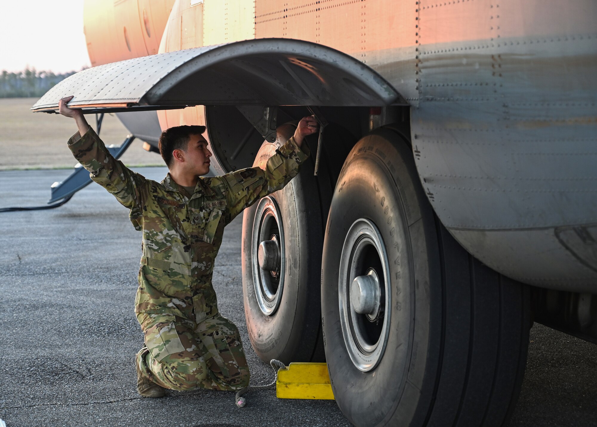 A loadmaster from the 327th Airlift Squadron performs pre-flight checks on a C-130J Super Hercules