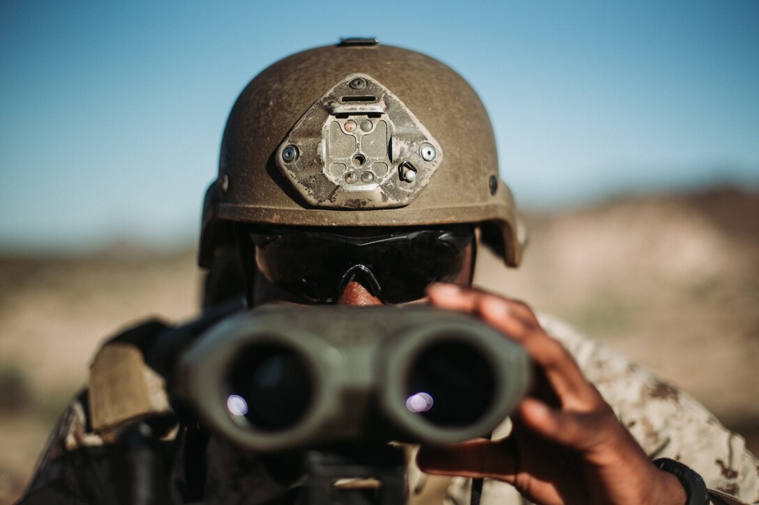 U.S. Marine Corps Lance Cpl. Deshawn Davidson, a forward observer with 1st Air Naval Gunfire Liaison Company, I Marine Expeditionary Force (MEF) Information Group, ranges a target during exercise Summer Fury 20 in Yuma, Arizona, July 14, 2020. Summer Fury 20 enhances Marine Air-Ground Task Force integration and increases aviation operations proficiency within I MEF. (U.S. Marine Corps photo by Cpl. Jennessa Davey)