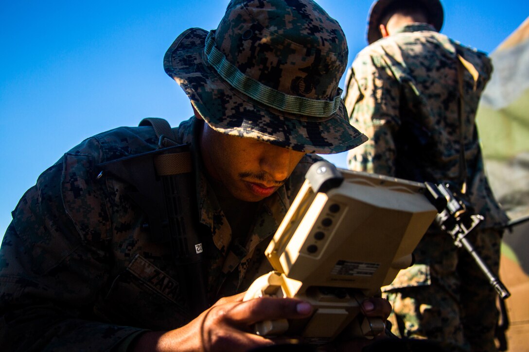 U.S. Marine Corps Lance Cpl. Jeremy Zapata, a ground electronics transmission systems maintainer with 2nd Ground Support Platoon, Battlefield Surveillance Company, 2nd Intelligence Battalion, II Marine Expeditionary Force Information Group, operates the Ground Based Observational Surveillance System (GBOSS) at Marine Corps Auxiliary Landing Field Bogue, N.C., on Nov. 16, 2021. The GBOSS is used to detect and track movement in field environments. (U.S. Marine Corps photo by Cpl. Alexander Ransom)