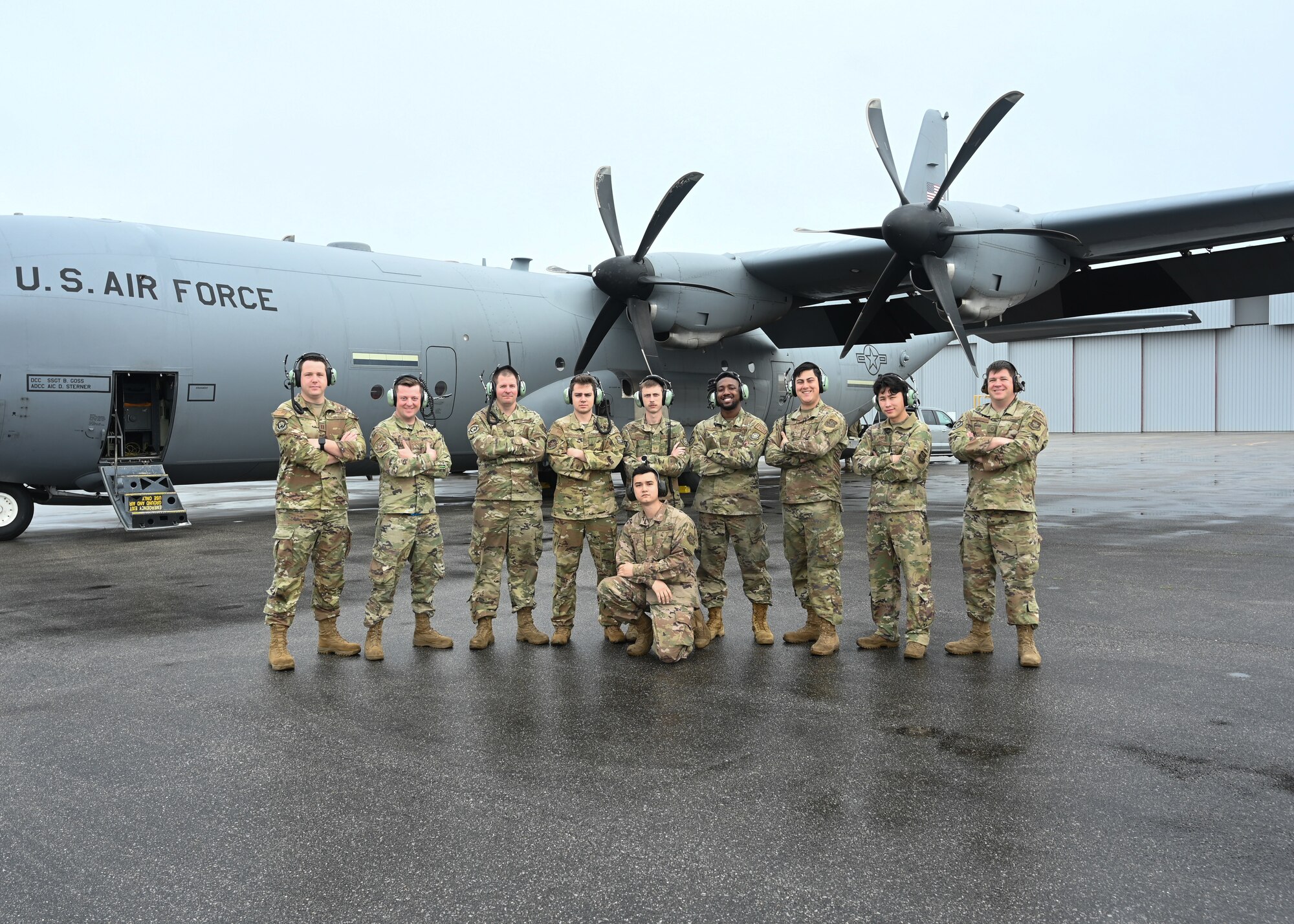 Airmen assigned to the 19th Aircraft Maintenance Squadron pose for a photo in front of a C-130J Super Hercules