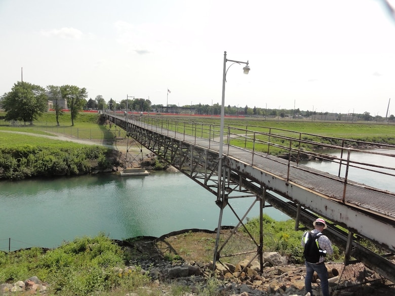 Detroit District Bridge Inspector Jacob Carr inspecting the columns and bearings at the north abutment of the Main Powerhouse Utility Bridge at the U.S. Army Corps of Engineers’ Soo Area Office in Sault Ste. Marie, Michigan in August 2021. This bridge will be replaced with a multi-span precast concrete girder bridge that will be located to the east of the existing bridge (left side in photo). U.S. Army Corps of Engineers photo by Andy Wadysz.