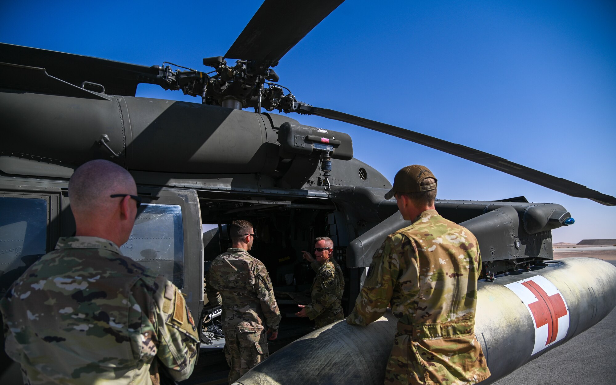 Leaders from the 378th Air Expeditionary Wing receive a tour of the HH-60M Black Hawk from the U.S. Army Soldiers of Task Force Longhorn at Prince Sultan Air Base, Kingdom of Saudi Arabia, Feb. 23, 2022. The HH-60M Black Hawk is a specialized multi-mission helicopter that can support medical, personnel or cargo transport missions. (U.S. Air Force photo by Staff Sgt. Christina Graves)