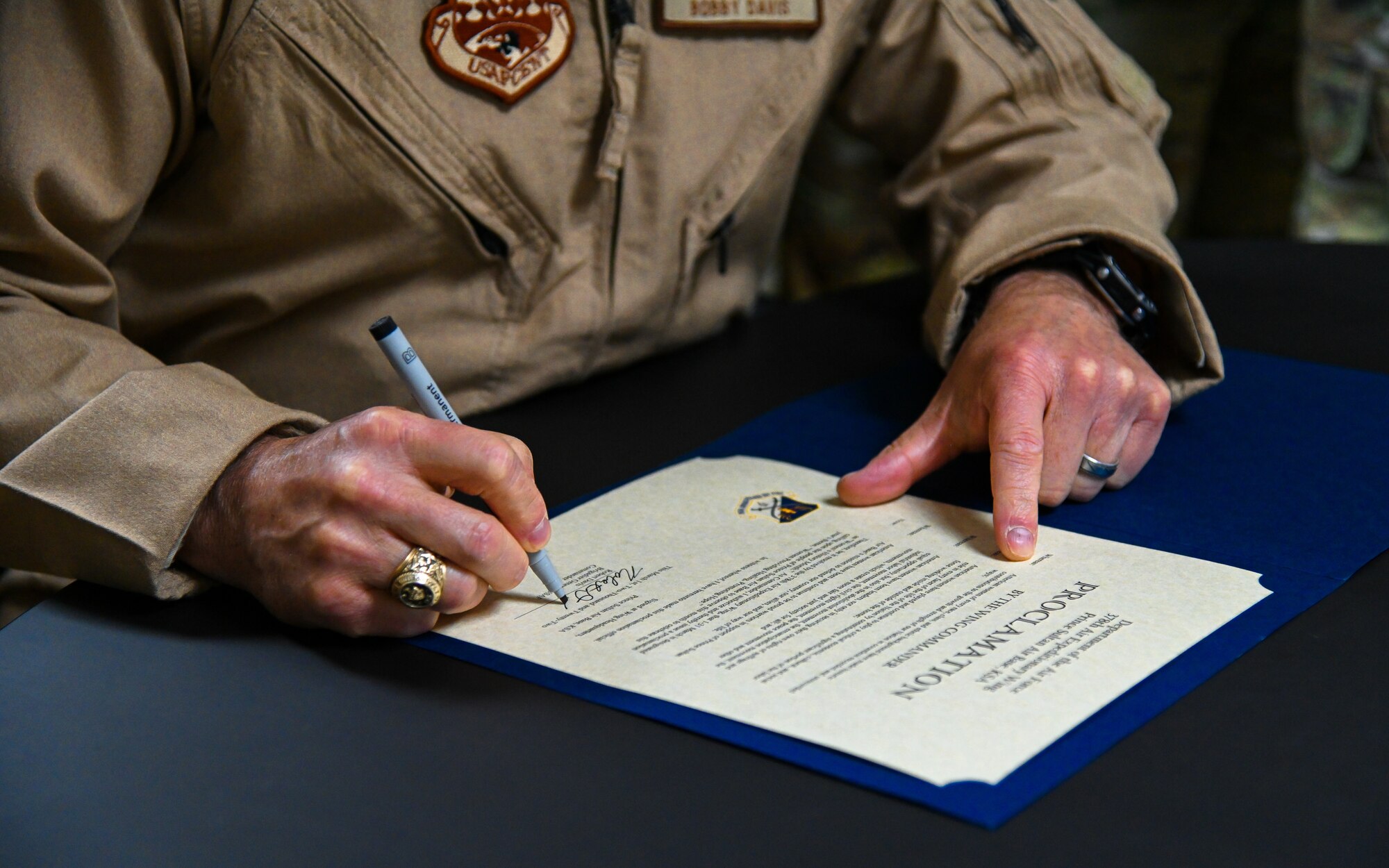 U.S. Air Force Brig. Gen. Robert Davis, 378th Air Expeditionary Wing commander, signs the official Prince Sultan Air Base Women’s History Month Proclamation alongside members of the installation Women’s Empowerment Group at Prince Sultan Air Base, Kingdom of Saudi Arabia, Mar. 1, 2022. The Women’s Empowerment Group is composed of women from sister services across the installation. (U.S. Air Force photo by Staff Sgt. Christina Graves)