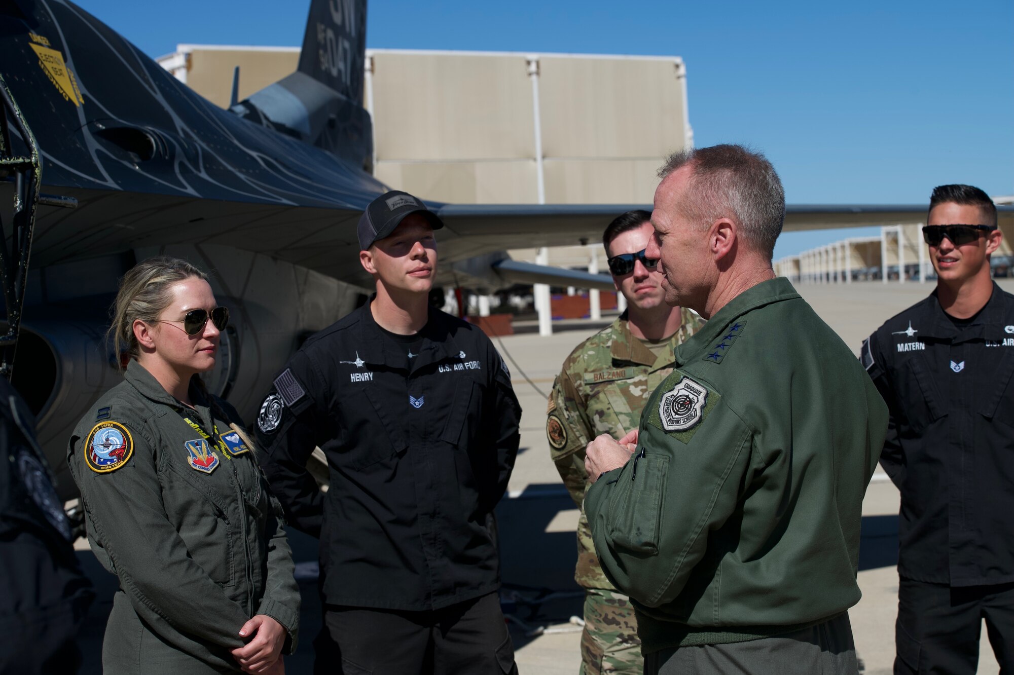 A picture of Viper Demo Team members talking with Gen Kelly.