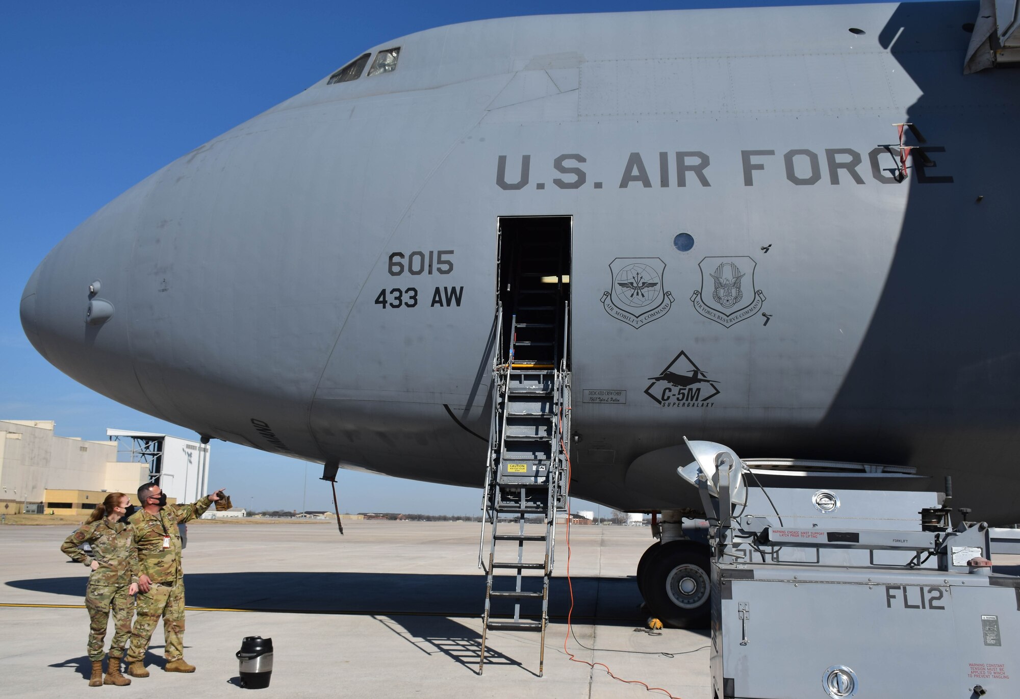 Senior Master Sgt. Richard Popp, 356th Airlift Squadron loadmaster, directs Staff Sgt. Sydney Leach, 433rd Logistics Readiness Squadron logistics planner, into a C-5M Super Galaxy aircraft at Joint Base San Antonio-Lackland, Texas, March 2, 2022. Leach participated in an anthropometric study as part of a career enlisted aviator evaluation to determine the minimum and maximum height requirements for C-5M personnel. (U.S. Air Force photo by Airman Mark Colmenares)