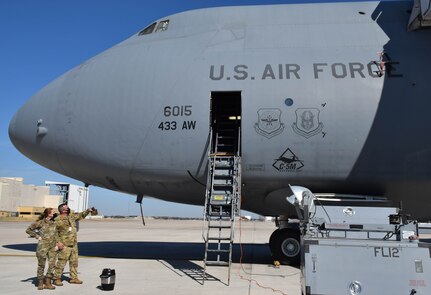 Senior Master Sgt. Richard Popp, 356th Airlift Squadron loadmaster, directs Staff Sgt. Sydney Leach, 433rd Logistics Readiness Squadron logistics planner, into a C-5M Super Galaxy aircraft at Joint Base San Antonio-Lackland, Texas, March 2, 2022. Leach participated in an anthropometric study as part of a career enlisted aviator evaluation to determine the minimum and maximum height requirements for C-5M personnel. (U.S. Air Force photo by Airman Mark Colmenares)