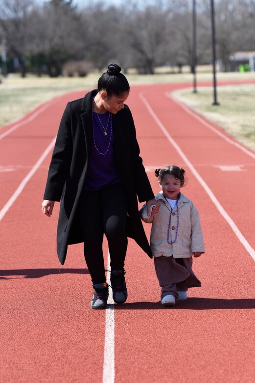 U.S. Air Force Senior Airman Nathasha Agley, 316th Security Support Squadron, Commander Support Staff administrator, walks with her daughter at the Women’s History Month awareness walkalk, Joint Base Andrews, Md., March 5, 2022.