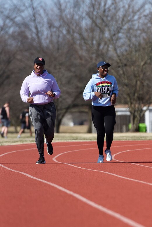U.S. Air Force Staff Sgts. Jonte Lett, 316th Security Support Squadron unit deployment manager, left, and Shyree McCants, 316th Security Forces Group esource advisor, run at the Women’s History Month awareness walk at Joint Base Andrews, Md., March 5, 2022.