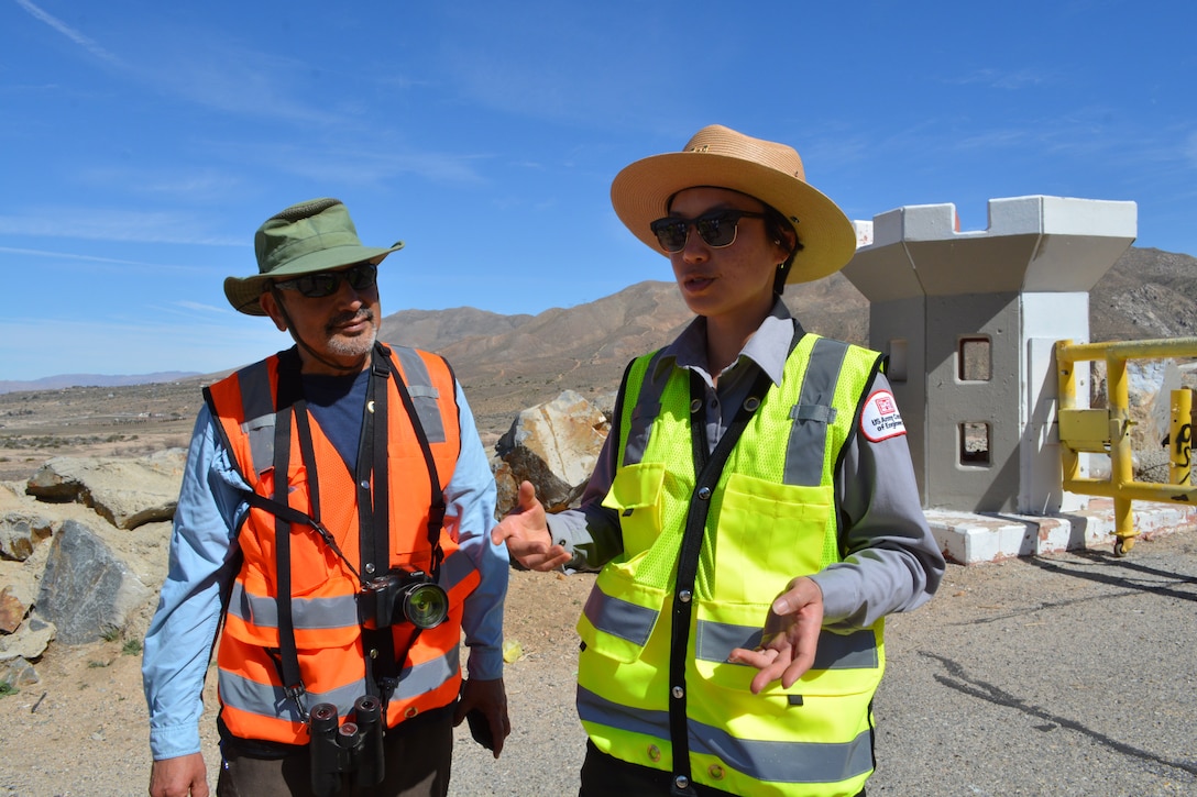 Jon Rishi, biologist with the Corps’ LA District, left, and LA District Park Ranger Connie Chan Le, right, talk about a security and restoration barrier plan to keep illegal off-road vehicle riders from trespassing into critical habitat March 2 at the Mojave River Dam in San Bernardino County, California.