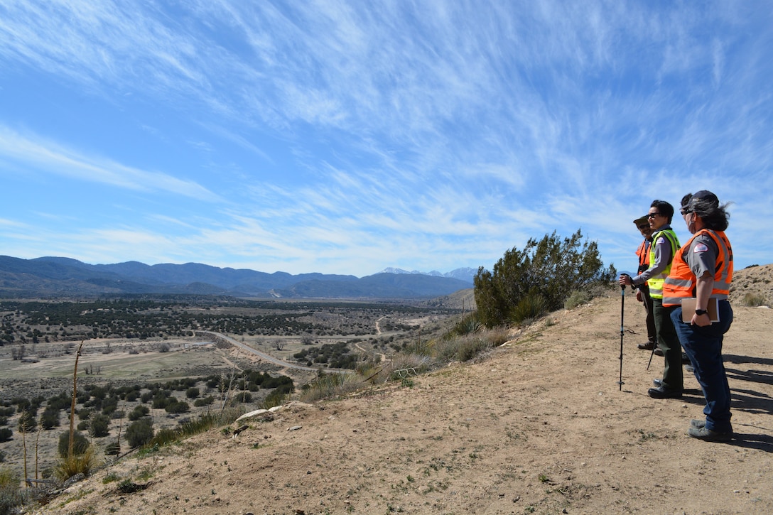 LA District Biologist Jon Rishi and LA District Park Rangers Connie Chan Le and Mai Linh Lawrence Skropanic take in the view across the Mojave River Dam basin in San Bernardino, California.