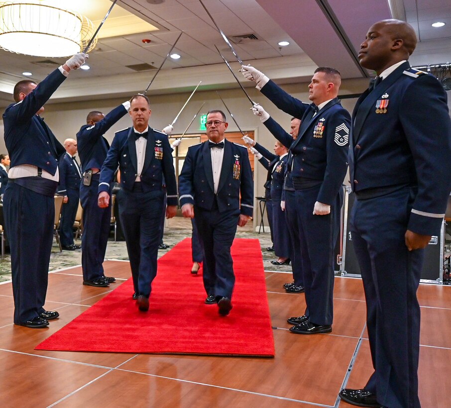 Col. Adam Willis, 315th Airlift Wing commander, Joint Base Charleston, South Carolina, and Col. Steven Priest, 315th Airlift Wing vice commander, walk down a traditional Air Force saber arch March 5, 2022 at the second annual Awards Gala. The 315th Airlift Wing hosted its second annual Awards Gala to highlight the accomplishments of the wing and its members (U.S. Air Force photo by Senior Airman William Brugge)