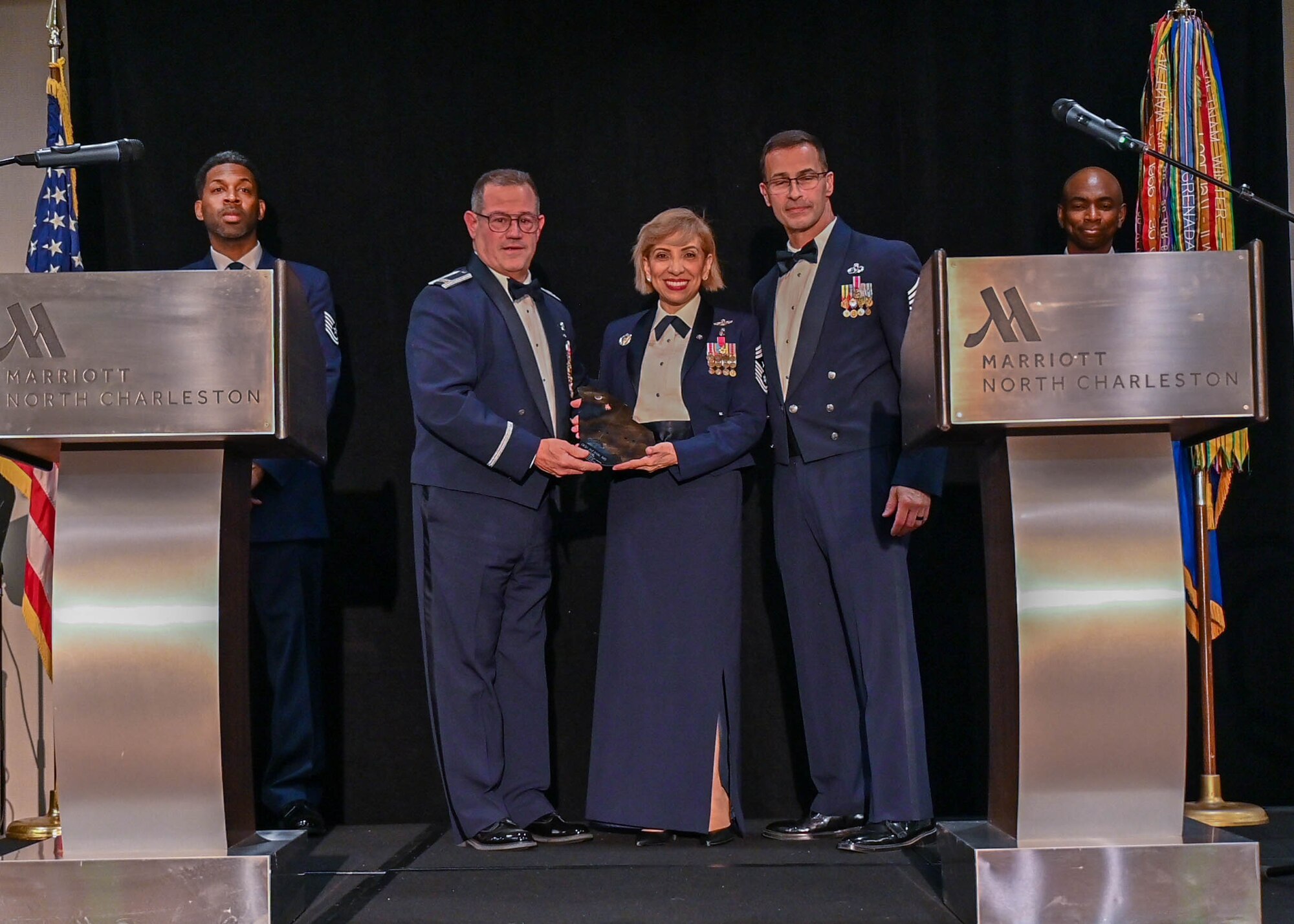 Col. Adam Willis, 315th Airlift Wing Commander, Joint Base Charleston, South Carolina, presents retired Chief Master Sgt. Ericka Kelly, 17th Command Master Sergeant for the Air Force Reserve Command, with a token of appreciation for speaking at the second annual Award Gala March 5, 2022. The 315th Airlift Wing hosted its second annual Awards Gala to highlight the accomplishments of the wing and its members. (U.S. Air Force photo by Senior Airman William Brugge)