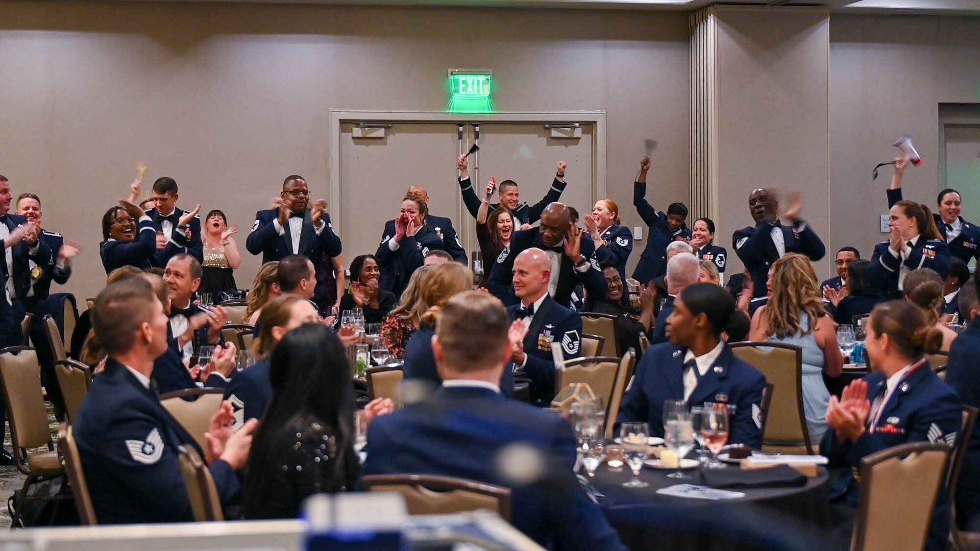 Members of the 315th Airlift Wing cheer for award winners during the second annual Awards Gala March 5, 2022. The 315th Airlift Wing hosted its second annual Awards Gala to highlight the accomplishments of the wing and its members.(U.S. Air Force photo by Senior Airman William Brugge)