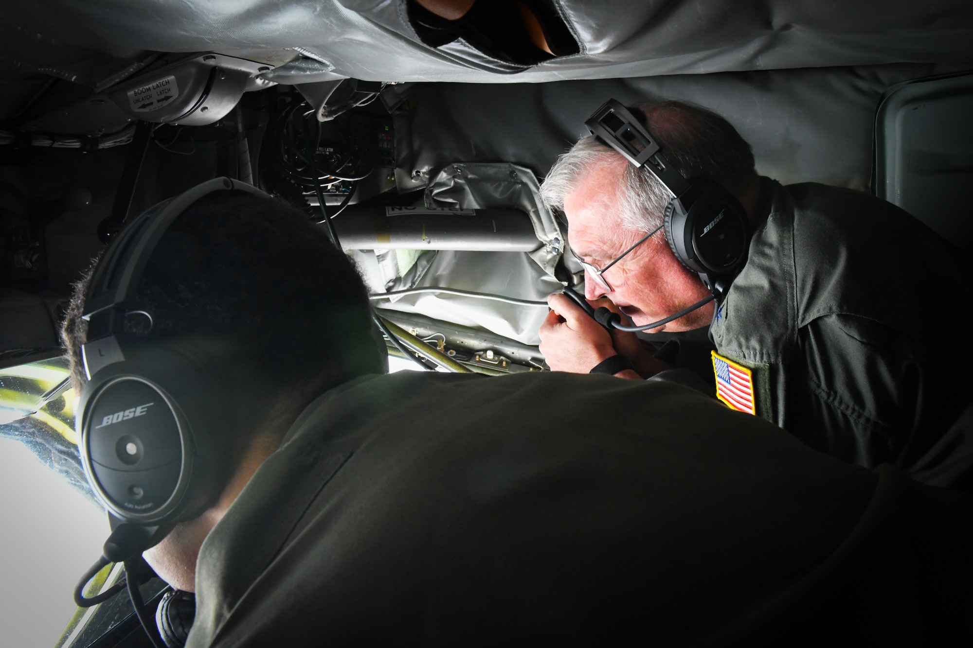 Photo of Lt. Gen. Ricky Rupp watching an F-15C Eagle being refueled.