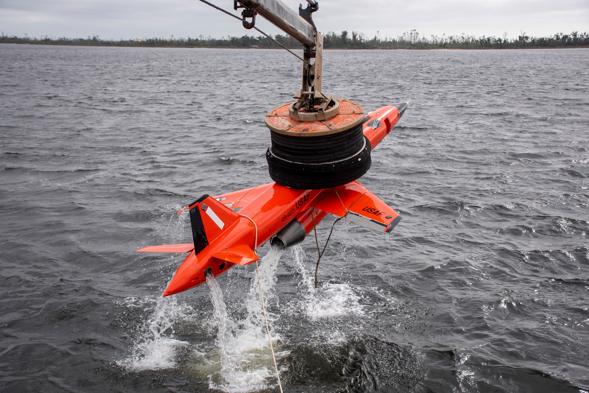 A BQM-167 subscale drone assigned to the 82nd Aerial Target Squadron, is lifted out of the water during a recovery demonstration in the East Bay near Tyndall Air Force Base, Florida, Dec. 17, 2021. Part of the 82nd ATRS’s responsibilities is to locate and extract all floating missiles, drones and aircraft debris within the 32 nautical-mile Waterborne Corridor, which helps keep the public safe and bring awareness to the mission. (U.S. Air Force photo by 1st Lt. Lindsey Heflin)