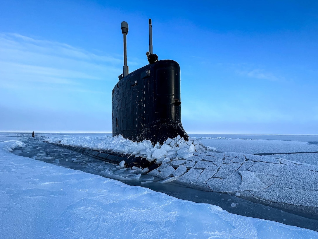 A submarine emerges in icy water.