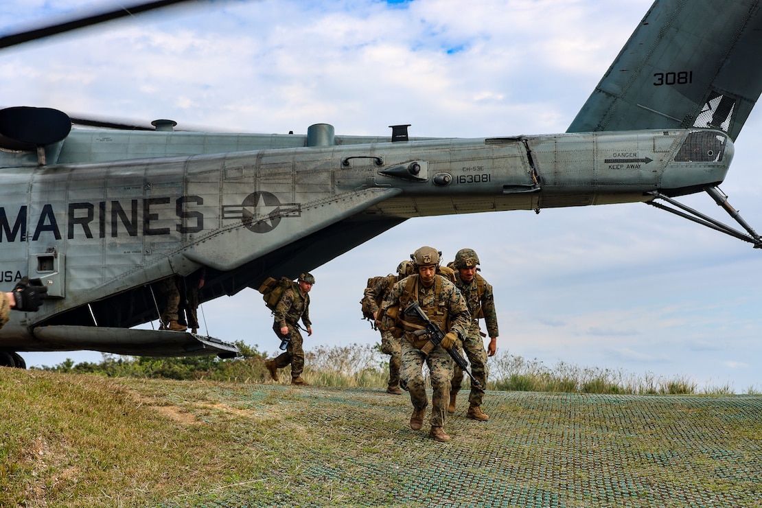 U.S. Marines disembark a CH-53 Super Stallion from Marine Heavy Helicopter Squadron 466 during Jungle Leaders Course (JLC) 2-22 at Jungle Warfare Training Center, Okinawa, Japan, Feb. 1, 2022. JLC sustains tactics, techniques, and procedures unique to jungle warfare operations. (U.S. Marine Corps photo by Lance Cpl. Natalie Greenwood)