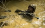 Cpl. Marcos Valencia maneuvers through a mud pit during the endurance course at the Jungle Warfare Training Center in Okinawa, Japan, Jan. 15, 2018. JWTC prepares Marines for operations in a jungle environment. Valencia, a Live oak, California native, is a team leader with India Company. 3rd Battalion, 3rd Marine Regiment, 3rd Marine Division. The mission of 3/3 Marines is to train and conduct theater security cooperation across the Pacific command area of responsibility in order to ensure access, deter threats, and build capacity with allies in the region, as well as being prepared to conduct crisis response and combat operations. (U.S. Marine Corps photo by Sgt. Ricky Gomez)