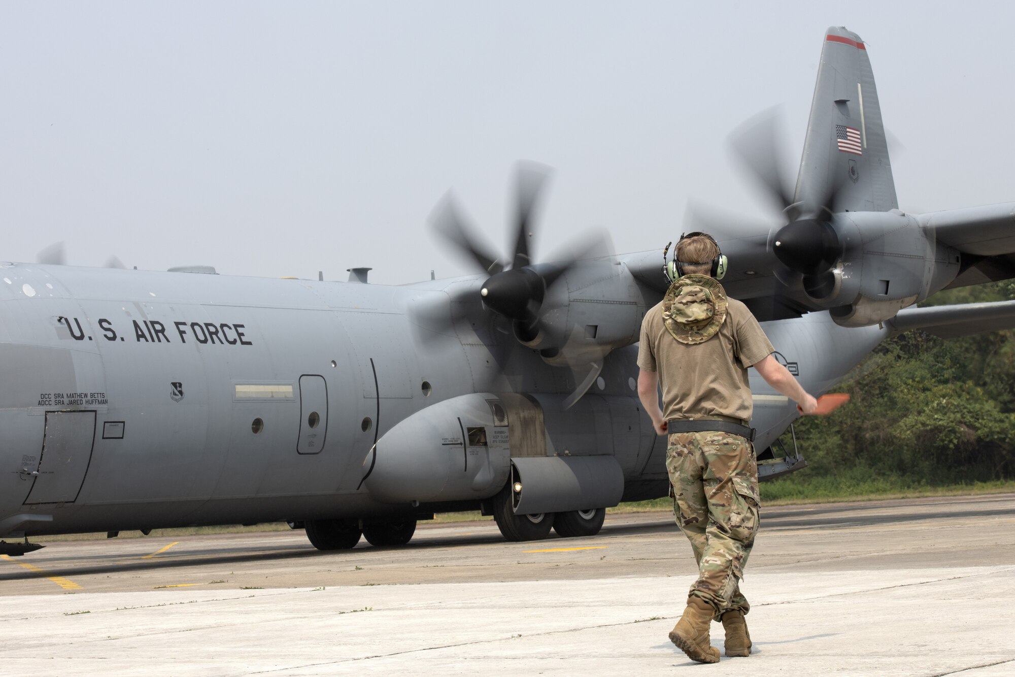 Senior Airman Logan Nawrocki, 36th Expeditionary Airlift Squadron integrated communication navigation mission systems and electronic warfare journeyman, marshals a C-130J Super Hercules during Exercise Cope South 2022, Feb. 24, 2022, at Bangladesh air force (BAF) Base Bangabandhu, Bangladesh. U.S. Air Force and BAF participants conducted static line and high altitude, low opening (HALO) jumps, low level flying, and night flights during the exercise to enhance their interoperability. Exercise Cope South is a bi-annual Pacific Air Forces-sponsored bilateral exercise that provides U.S. and Bangladesh air forces the opportunity to work together while performing tactical airlift scenarios.