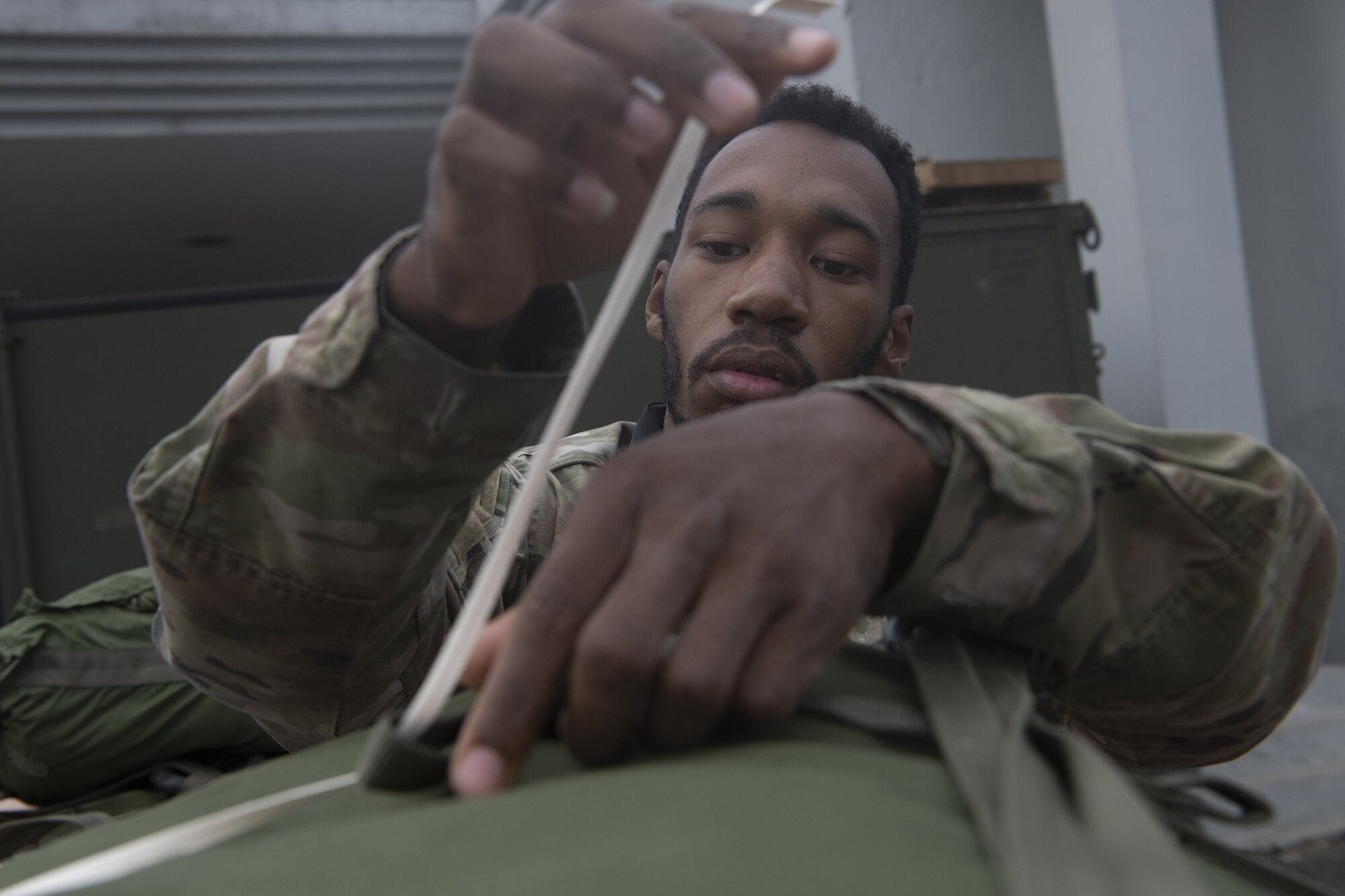 Airman 1st Class Terrell Coleman, 36th Expeditionary Airlift Squadron combat mobility technician, prepares containerized delivery systems (CDS) for air drop training during Exercise Cope South 2022, Feb. 20, 2022, at Bangladesh air force (BAF) Base Bangabandhu, Bangladesh. The CDSs were used by the 36th EAS and BAF to perform air drop training as part of the exercise. Exercise Cope South provides an opportunity for Pacific Air Forces and the Bangladesh armed forces to strengthen their relationship and enhance interoperability, to operate more effectively together when needed.