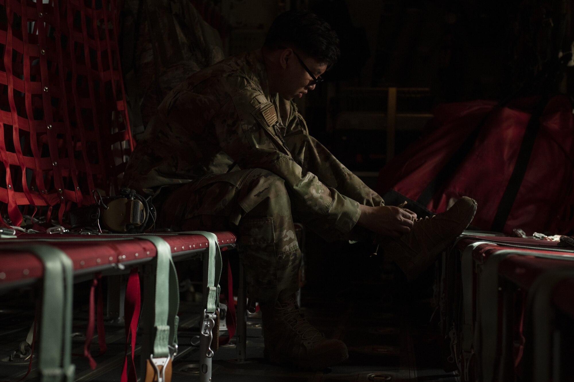 Staff Sgt. Andy Massa, 36th Expeditionary Airlift Squadron dedicated crew chief, tightens the laces of his boot while enroute to conduct an air drop mission with the Bangladesh air force (BAF) during Exercise Cope South 2022, Feb. 20, 2022, over Bangladesh. Airmen assigned to the 36th EAS worked side-by-side with BAF pilots and maintainers to perform air drops and low level flying as part of the day’s tasks. Exercise Cope South provides an opportunity for Pacific Air Forces and the Bangladesh armed forces to strengthen their relationship and enhance interoperability, to operate more effectively together when needed.