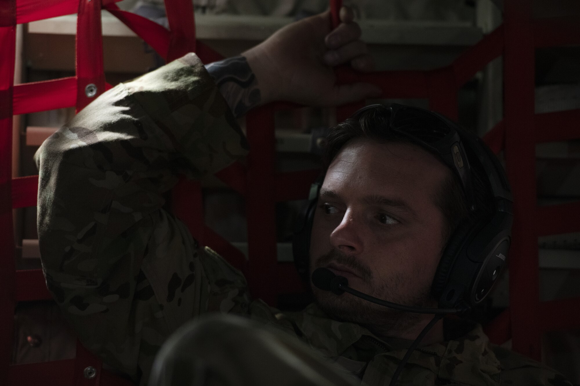 Tech Sgt. Wesley Zech, 36th Expeditionary Airlift Squadron loadmaster, listens to communications with his aircrew on a C-130J Super Hercules, while enroute to a drop zone to conduct an air drop mission with the Bangladesh air force (BAF) during Exercise Cope South 2022, Feb. 20, 2022, over Bangladesh. Airmen assigned to the 36th EAS worked side-by-side with BAF pilots and maintainers to perform air drops and low level flying as part of the day’s tasks. Exercise Cope South provides an opportunity for Pacific Air Forces and the Bangladesh armed forces to strengthen their relationship and enhance interoperability, to operate more effectively together when needed.
