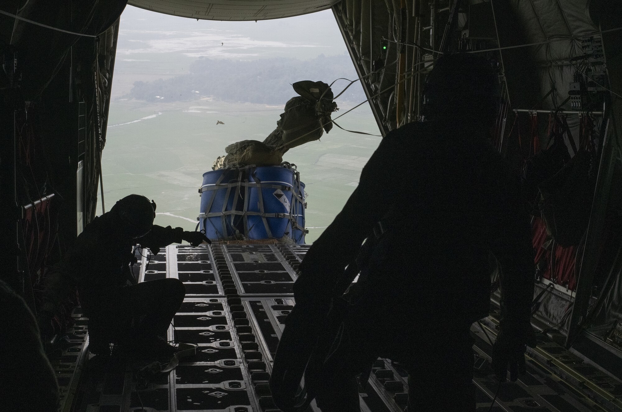 Staff Sgt. McArthur Posey, left, and Tech Sgt. Wesley Zech, right, 36th Expeditionary Airlift Squadron loadmasters, release containerized delivery systems (CDS) for air drop off the ramp of a C-130J Super Hercules during Exercise Cope South 2022, Feb. 20, 2022, over a drop zone near Sylhet, Bangladesh. Airmen assigned to the 36th EAS worked side-by-side with Bangladesh air force (BAF) pilots and maintainers to perform air drops and low level flying as part of the day’s tasks. Exercise Cope South provides an opportunity for U.S. and Bangladesh forces to strengthen their partnership to enhance their interoperability in efforts to maintain regional stability.