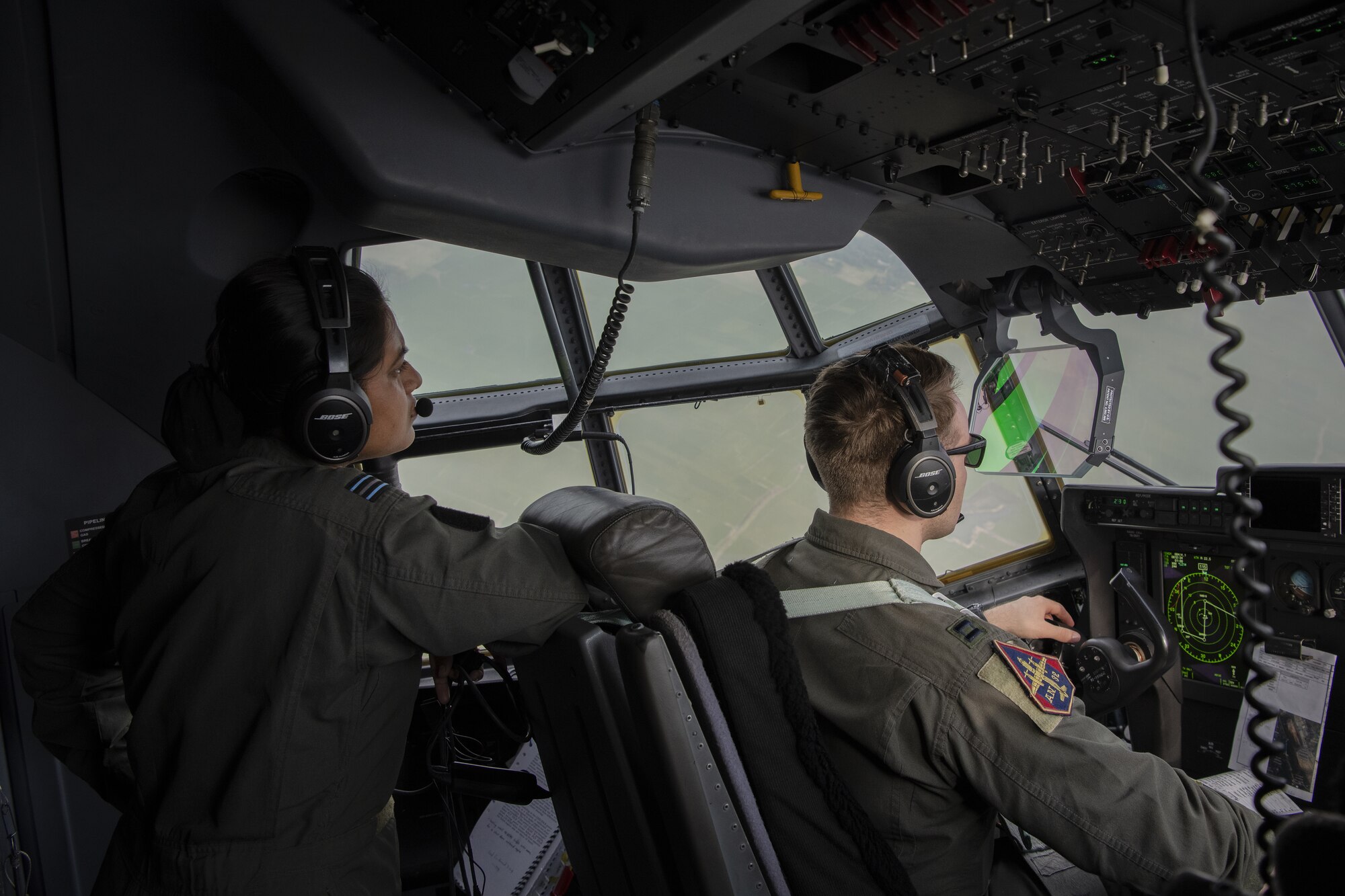 Bangladesh air force (BAF) Flight Lieutenant Israt Drishty, C-130 Hercules pilot, talks with U.S. Air Force pilots assigned to the 36th Expeditionary Airlift Squadron through her headset during low level flying demonstration as part of Exercise Cope South 2022, Feb. 20, 2022, over Bangladesh. Airmen assigned to the 36th EAS work side-by-side with BAF pilots and maintainers to perform training tasks and evaluate proficiency during the exercise. Exercise Cope South provides an opportunity for Pacific Air Forces and the Bangladesh armed forces to strengthen their relationship and enhance interoperability, to operate more effectively together when needed.