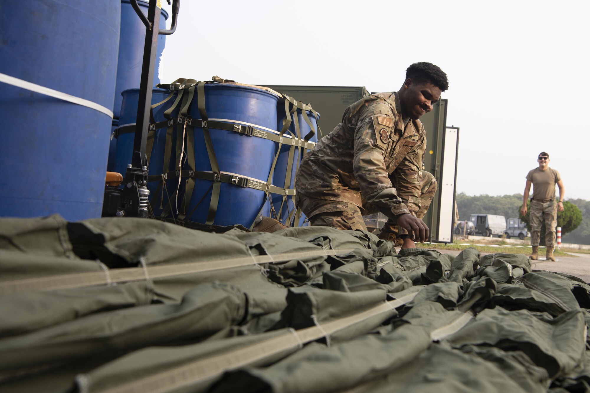 Airman 1st Class Jalen Riley, 36th Expeditionary Airlift Squadron combat mobility technician, prepares parachutes for static line jumps during Exercise Copes South 2022 Feb. 22, 2022, at Bangladesh air force (BAF) Base Bangabandhu, Bangladesh. U.S. and Bangladesh air forces conducted static line and high altitude, low opening (HALO) jumps during the exercise. The bilateral exercise provides an opportunity for Pacific Air Forces and the BAF to strengthen their relationship and enhance interoperability, to operate more effectively together when needed.