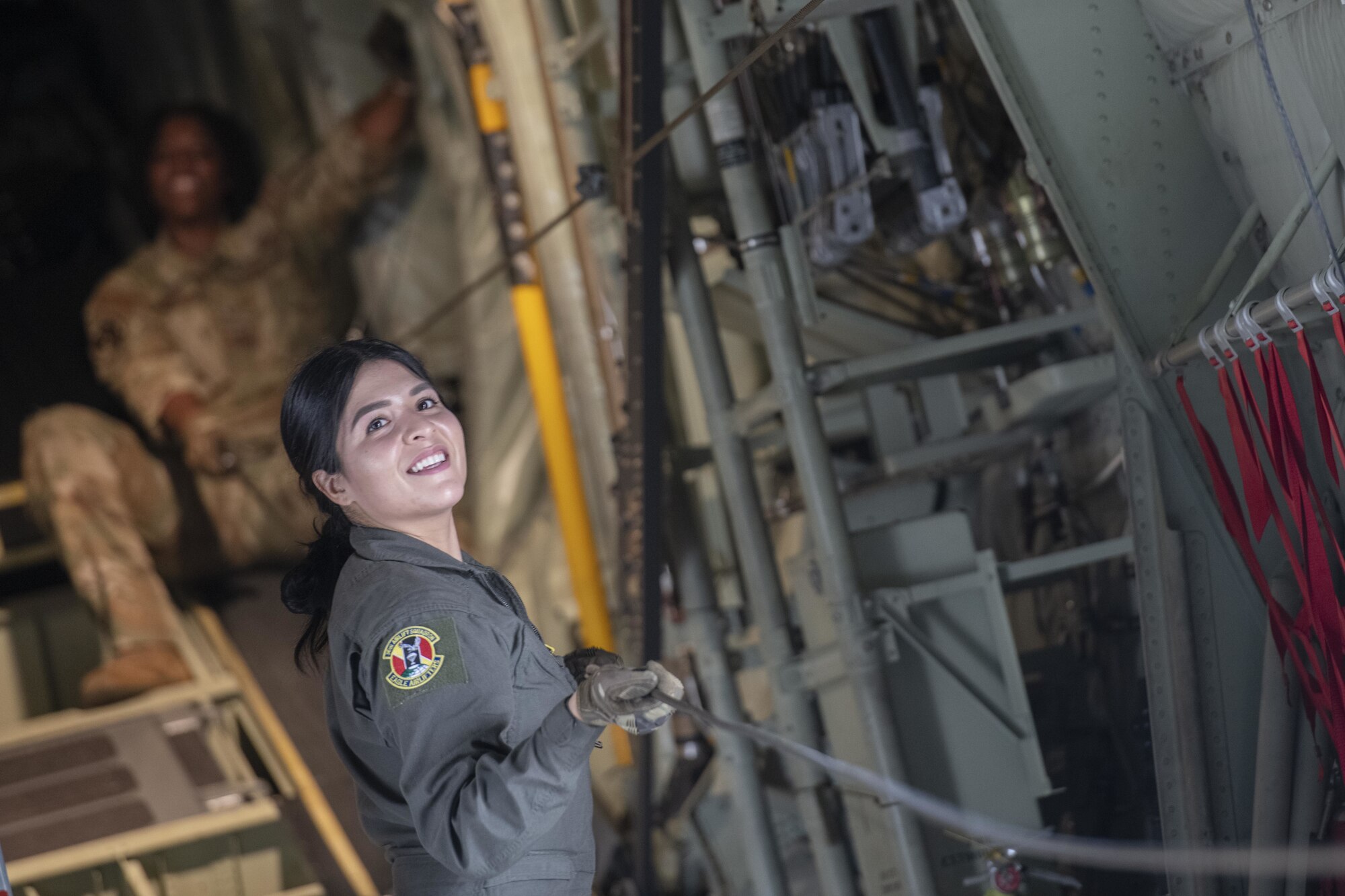 Senior Airman Kristen Garcia, foreground, and Staff Sgt. Toiannah Campbell, 36th Expeditionary Airlift Squadron loadmasters, prepare cable for static line jumps during Exercise Cope South 2022 Feb. 22, 2022, at Bangladesh air force (BAF) Base Bangabandhu, Bangladesh. U.S. and Bangladesh air forces conducted static line and high altitude, low opening (HALO) jumps during the exercise. The bilateral exercise provides an opportunity for Pacific Air Forces and the BAF to strengthen their relationship and enhance interoperability, to operate more effectively together when needed.