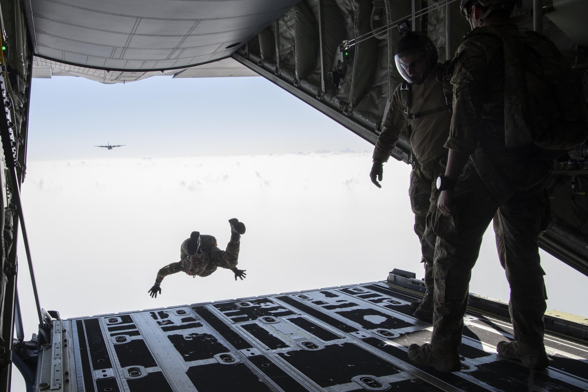 U.S. Air Force Tech Sgt. Seth Sarret, 36th Expeditionary Airlift Squadron jumpmaster, observes Bangladesh armed forces members as they jump from a C-130J Super Hercules during a high altitude, low opening (HALO) jump as part of Exercise Cope South 2022, Feb. 22, 2022, over Bangladesh. U.S. and Bangladesh air forces (BAF) conducted static line and HALO jumps during the exercise. The bilateral exercise provides an opportunity for Pacific Air Forces and the BAF to strengthen their relationship and enhance interoperability, to operate more effectively together when needed.