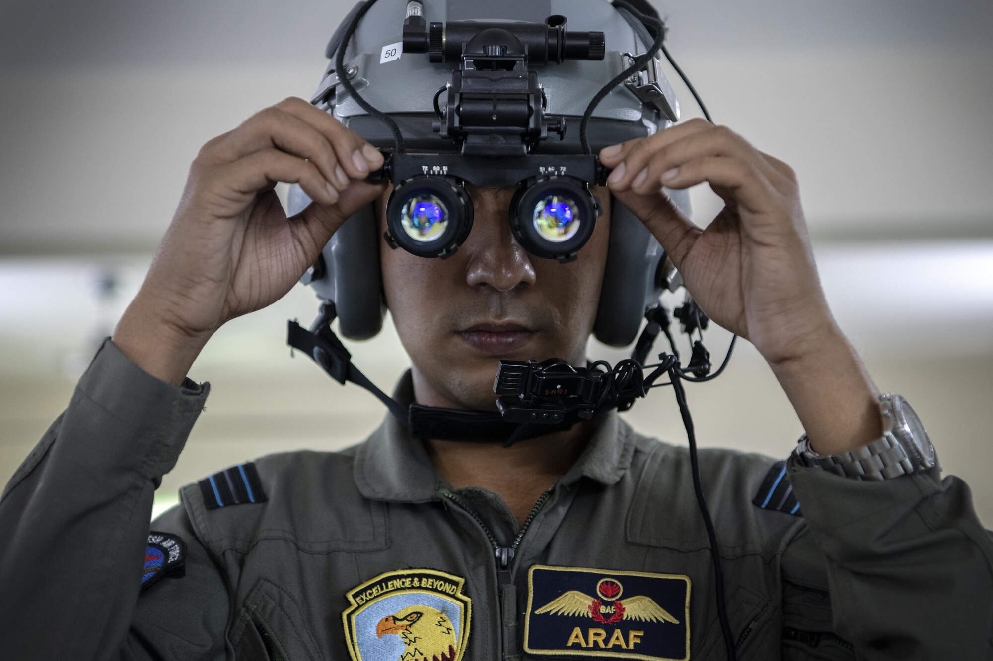 Bangladesh air force (BAF) C-130 pilot, Flight Lieutenant Araf Billah, adjusts night vision goggles in preparation for a night sortie during Exercise Cope South 2022, Feb. 24, 2022, at BAF Base Bangabandhu, Bangladesh. U.S. Air Force and BAF pilots exchanged techniques for flying in low light conditions as part of the exercise. Exercise Cope South is a bi-annual Pacific Air Forces-sponsored bilateral tactical airlift exercise, intended to enhance U.S. and Bangladesh forces’ ability to operate together.